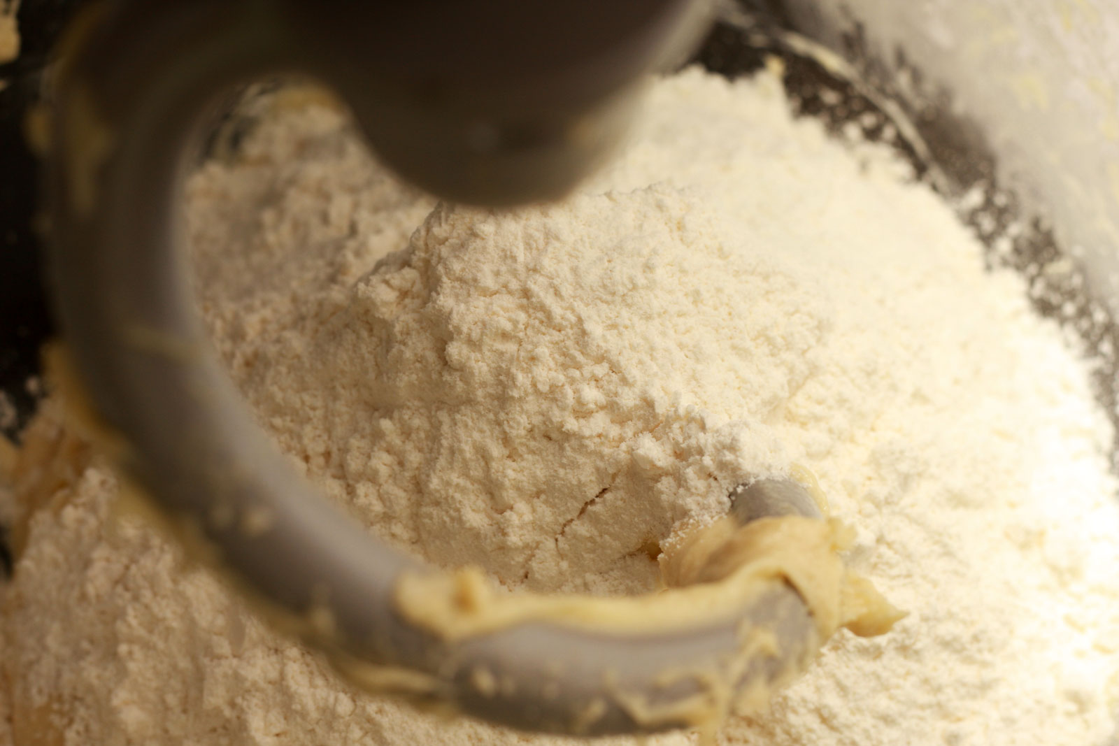 Additional flour is worked into the dough using a dough hook