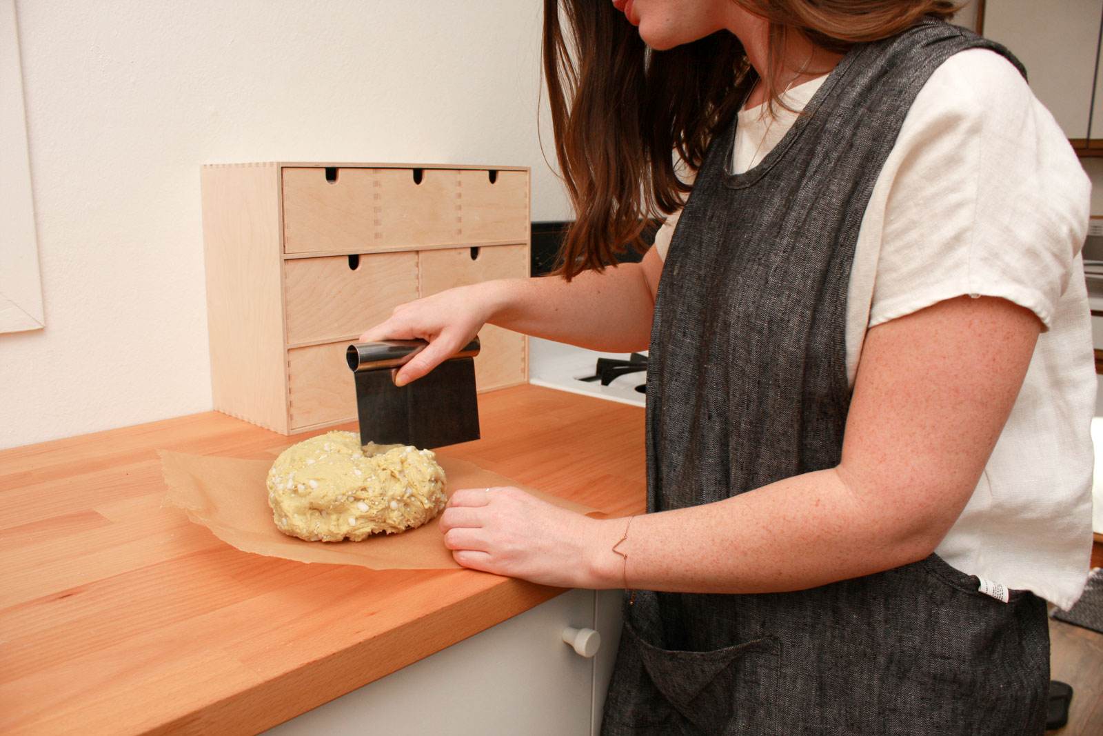 Alyssa cuts a ball of waffle dough