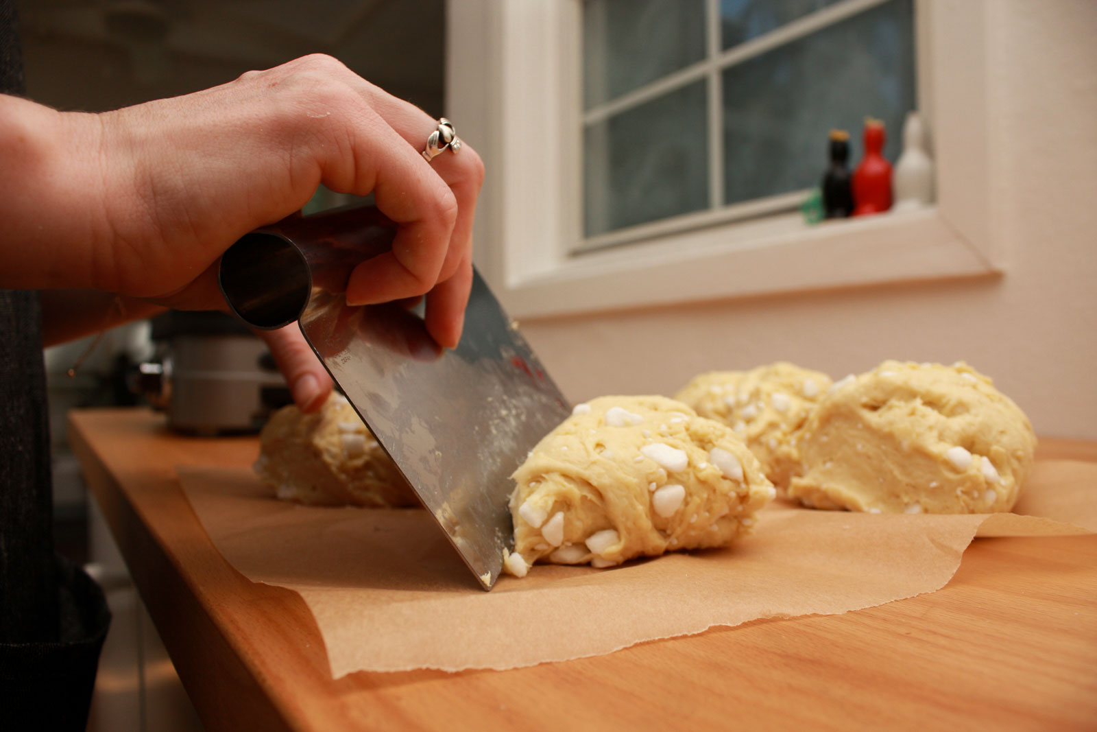 Alyssa cuts the waffle dough with a bench scraper