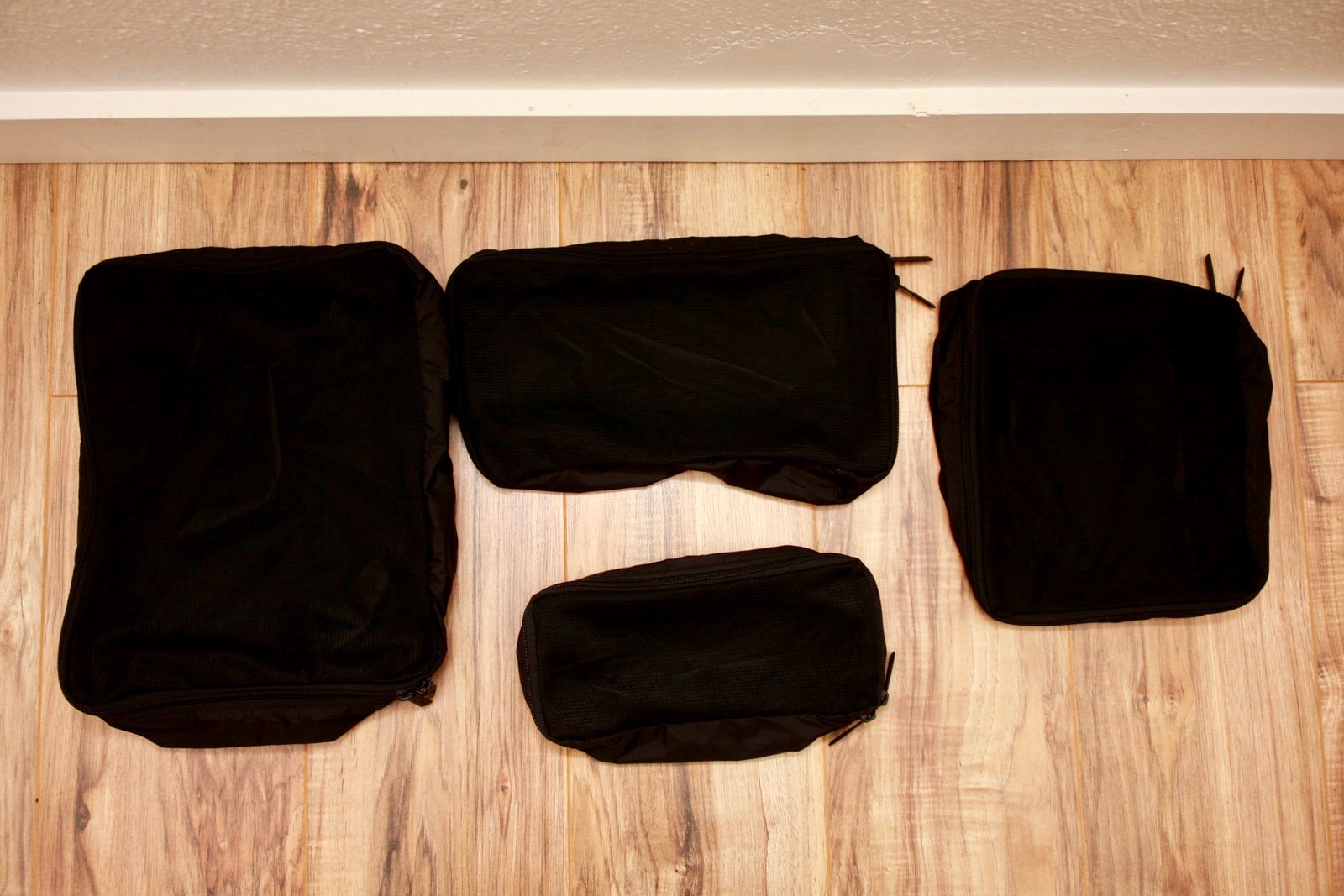 A set of four empty Away Packing Cubes