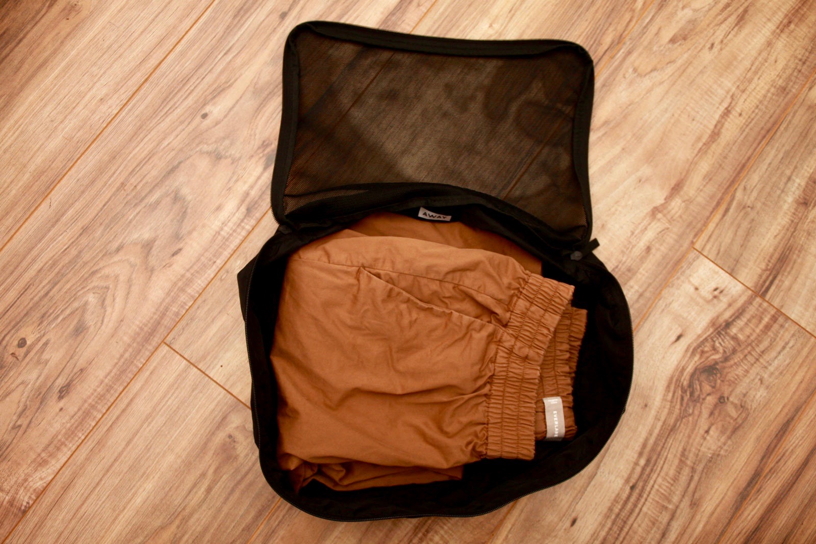 A pair of pants in an Away packing cube