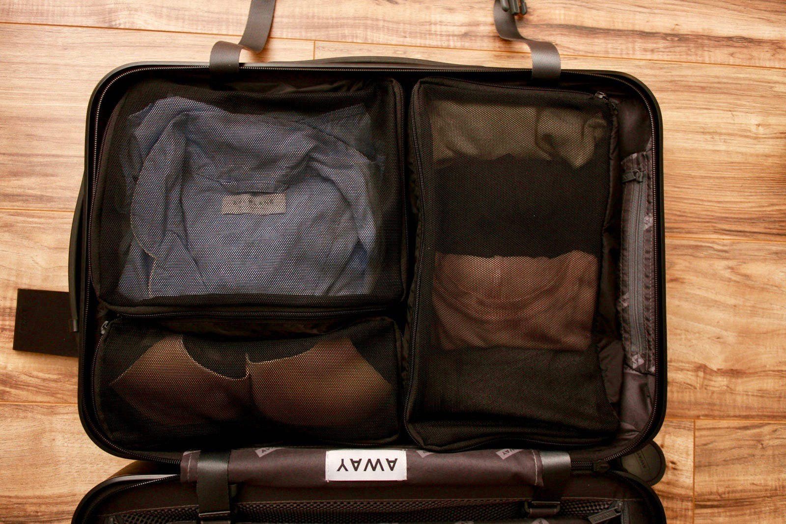 Three Packing Cubes inside an Away suitcase