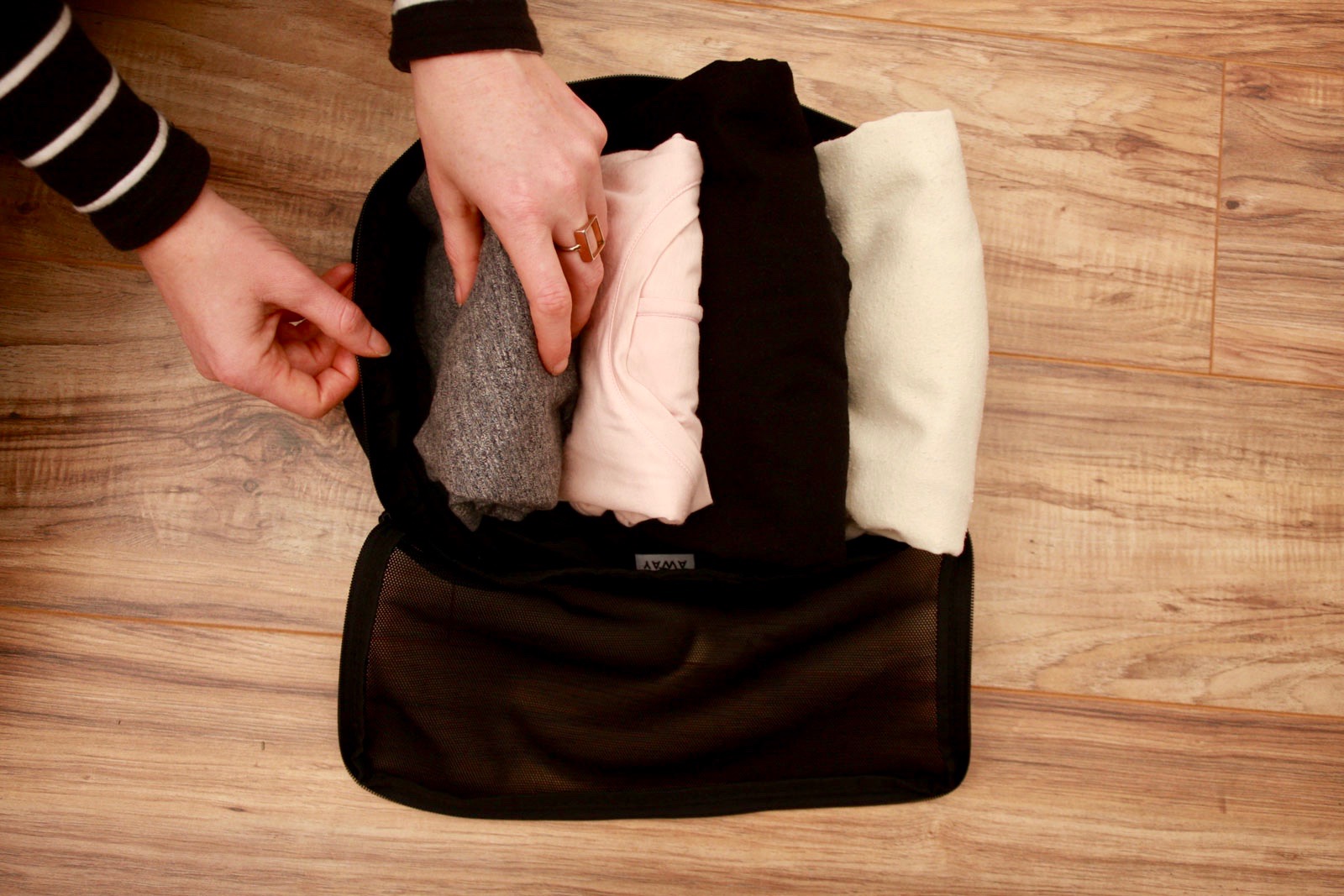 Alyssa files four t-shirts into a packing cube