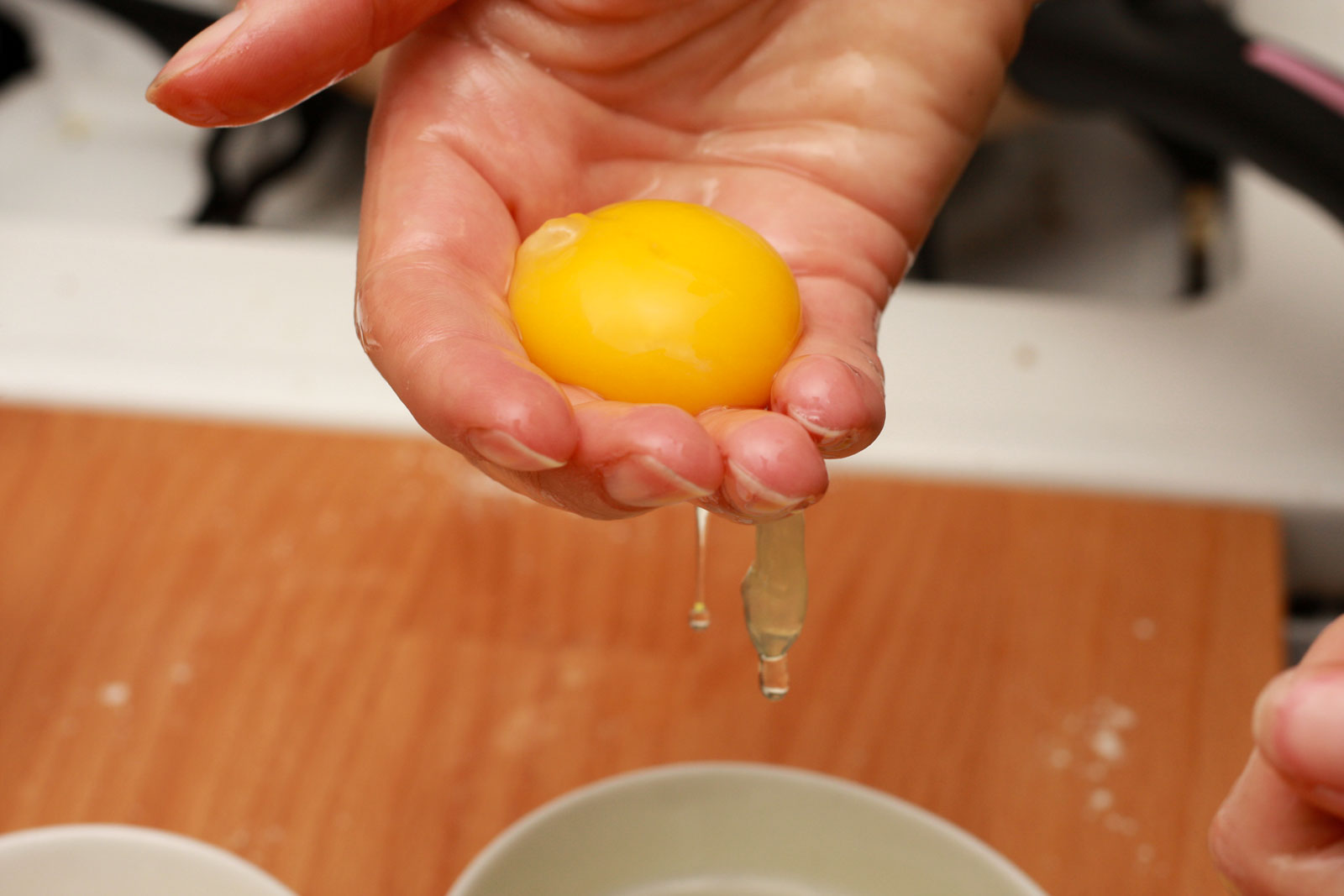 Separating egg yolks from whites by hand