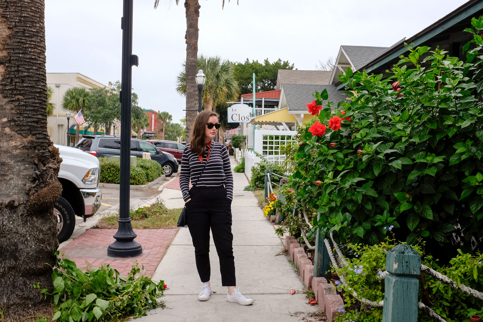 Alyssa stands on a sidewalk in Amelia Island