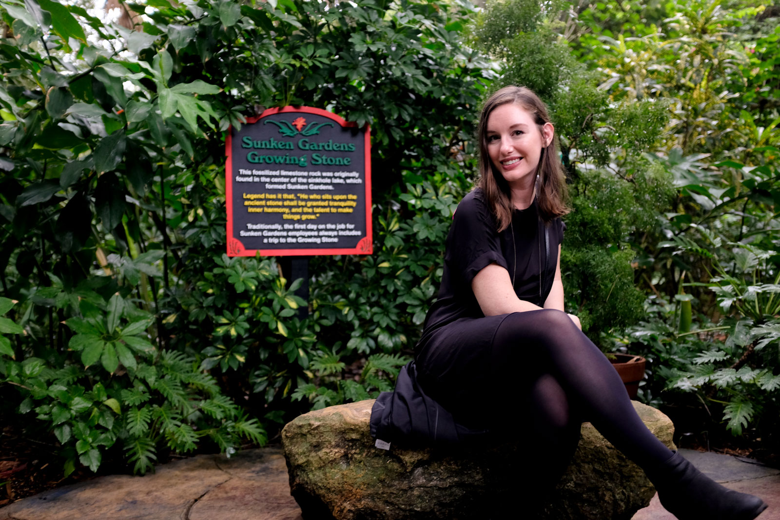 Alyssa sits on the Growing Stone at Sunken Gardens in St. Petersburg