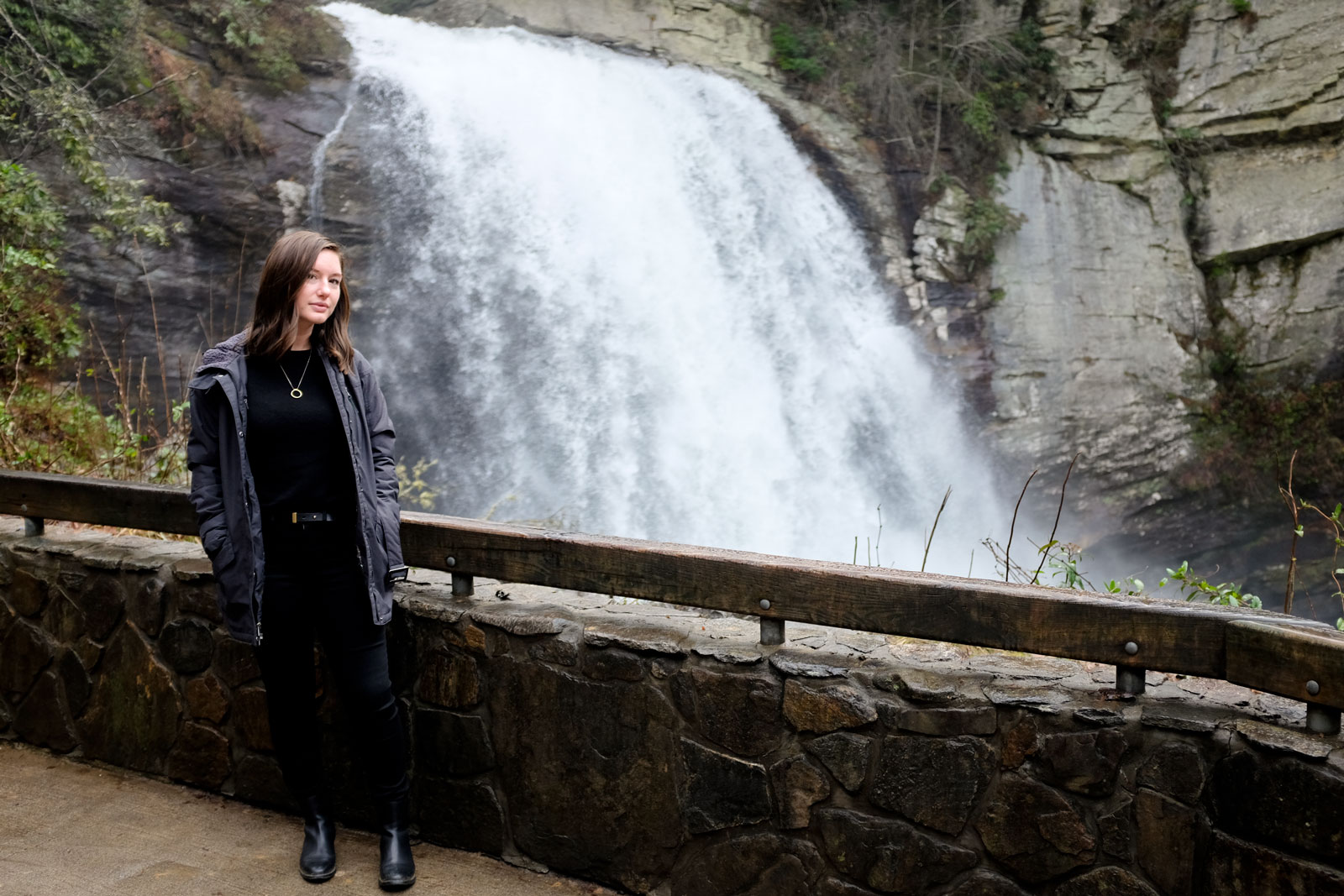 Alyssa stands in front of Looking Glass Falls near Asheville