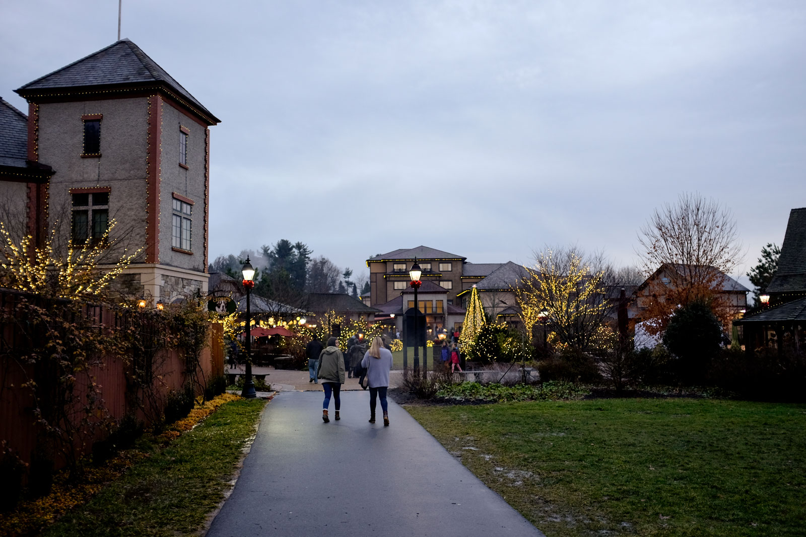 People walk on the Biltmore Grounds, decorated for the holidays