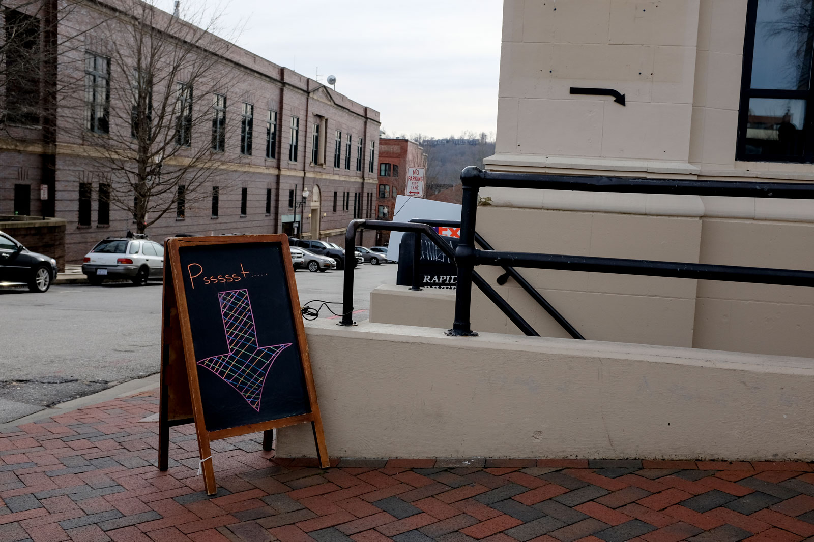 A sandwich board reads "psssst" in downtown Asheville
