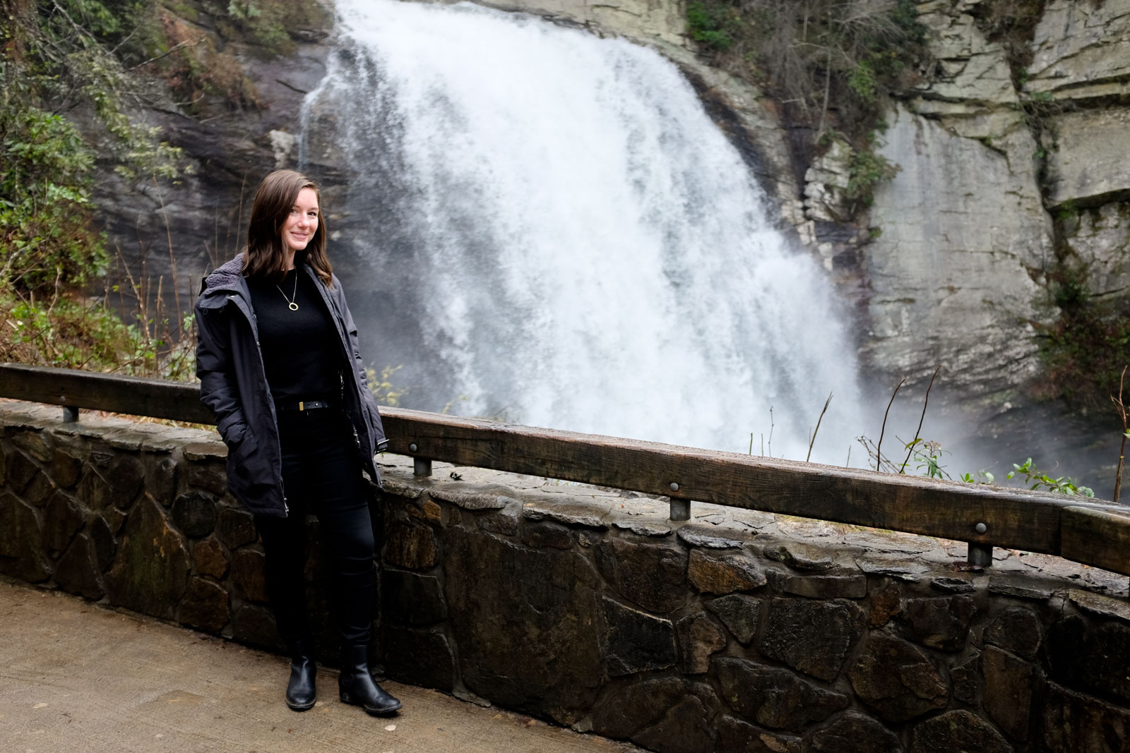 Alyssa stands in front of Looking Glass Falls