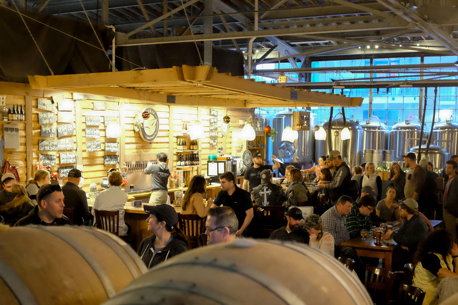 A crowd of people gather at Twin Leaf Brewery in Asheville