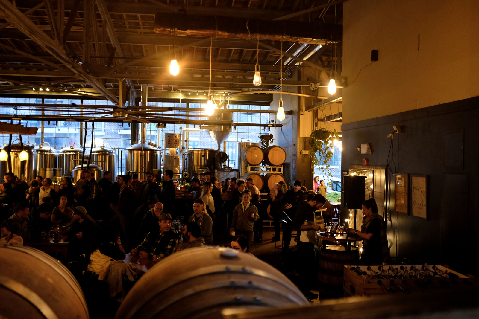 A crowd gathers over beers at Twin Leaf in Asheville 