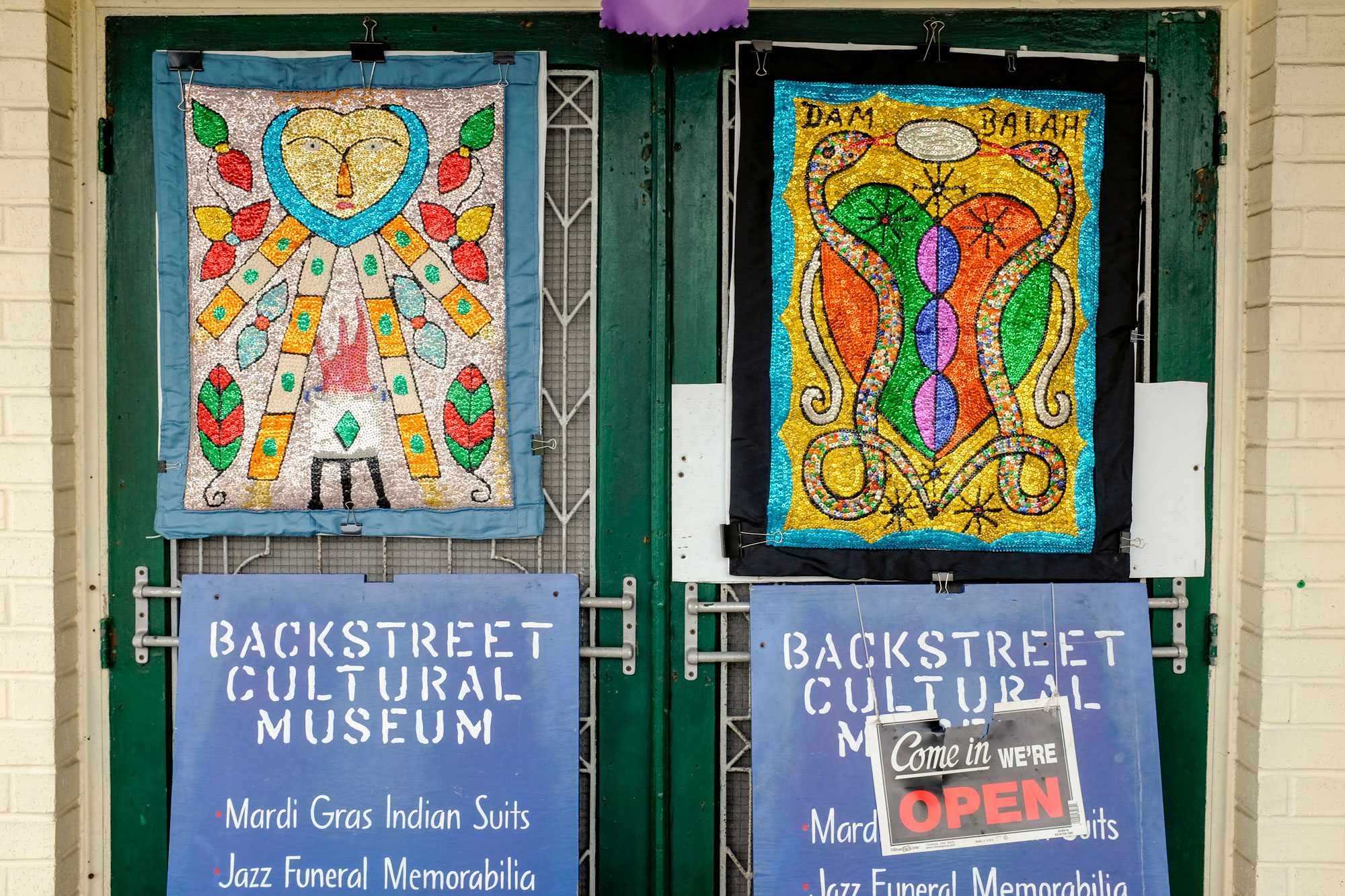 Doors of Backstreet Cultural Museum and open sign