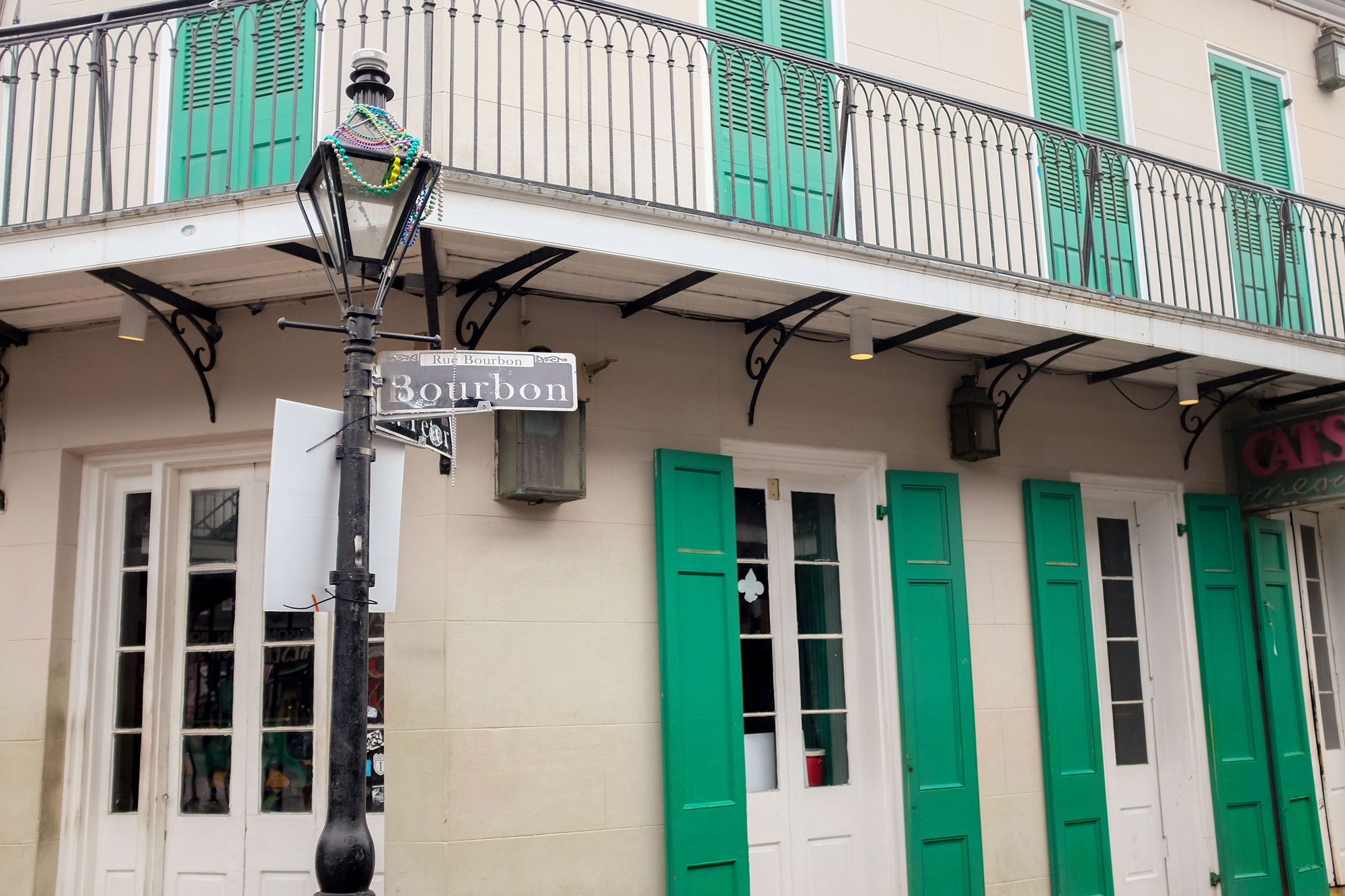 Bourbon Street sign with beads on it