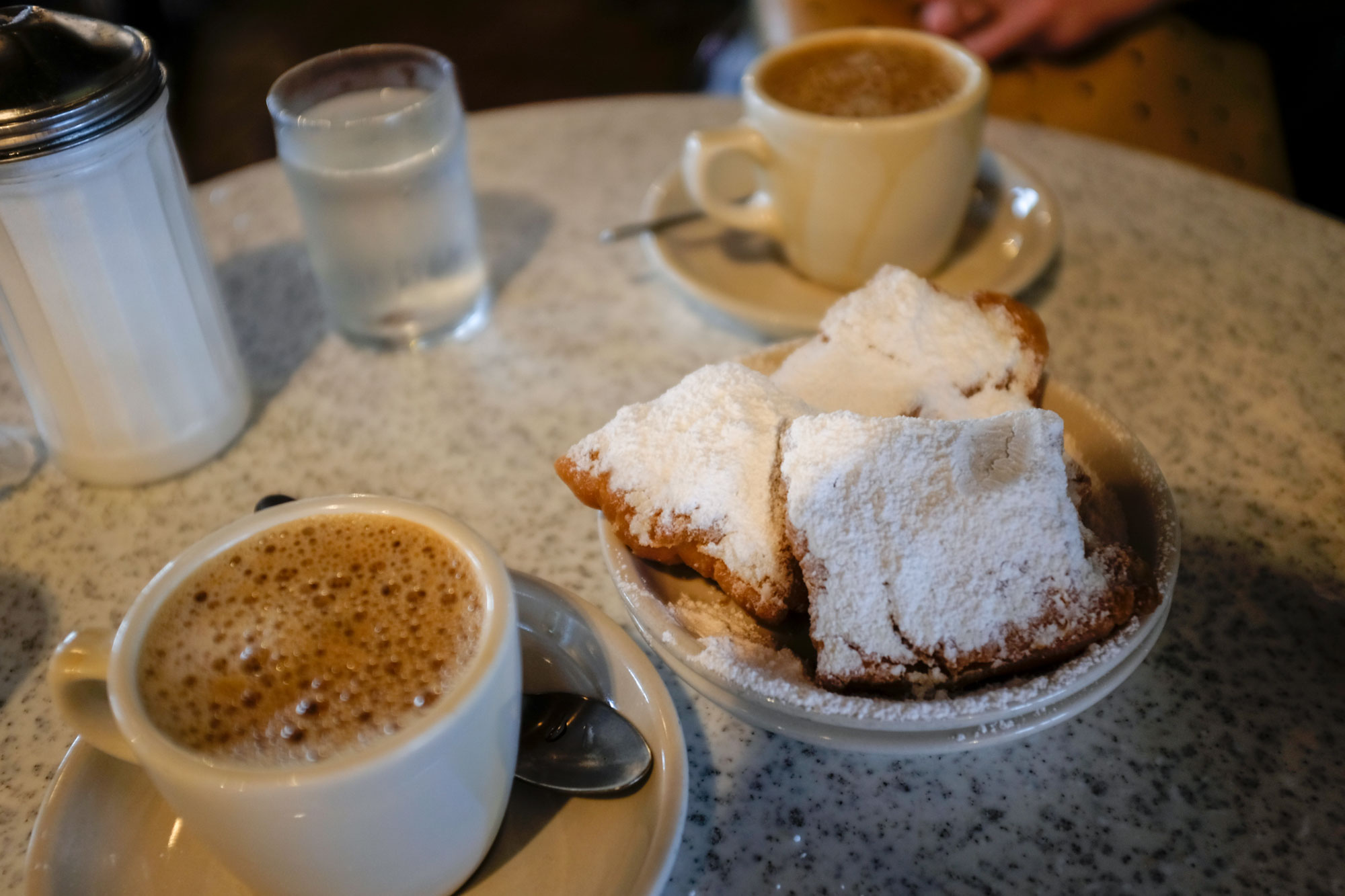 Table with beignets and cafe au lait