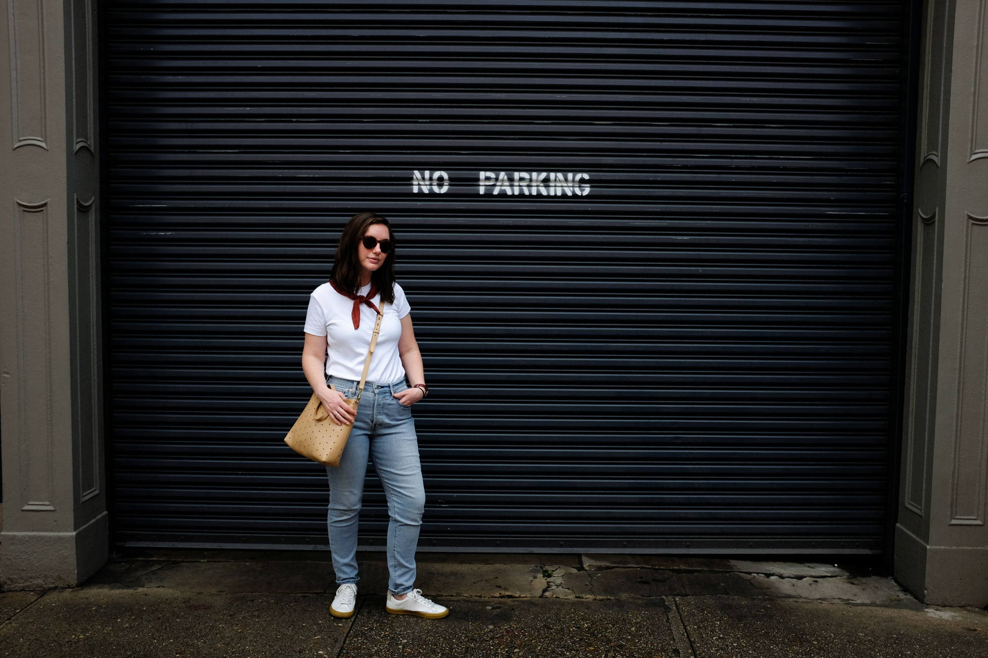 Alyssa standing in front of a sign that says No Parking