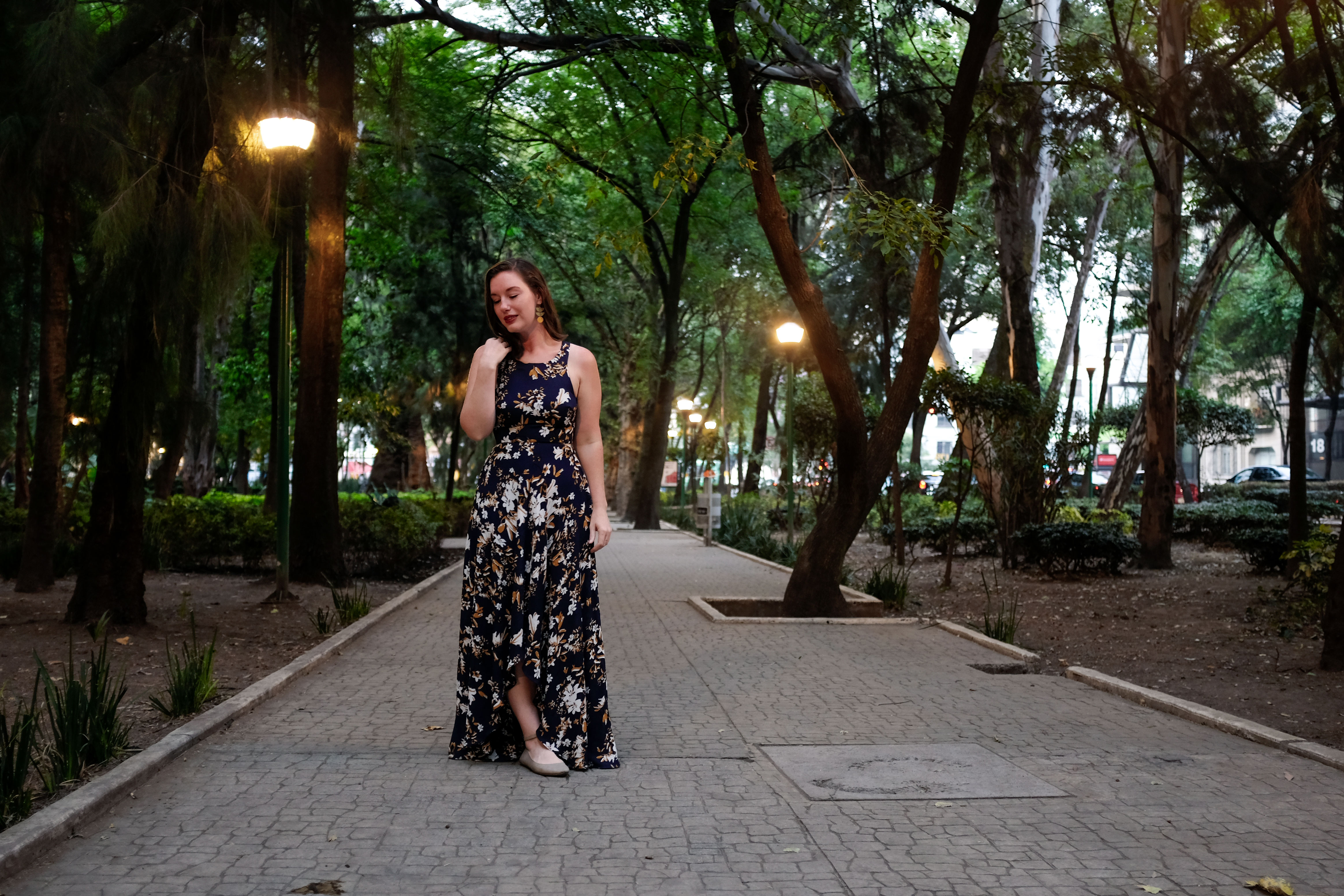 Alyssa in Parque Espana in a long floral dress and neutral shoes