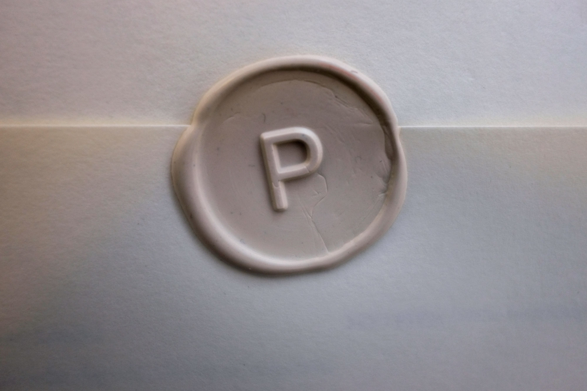 Envelope with a wax seal and the letter P stamped in