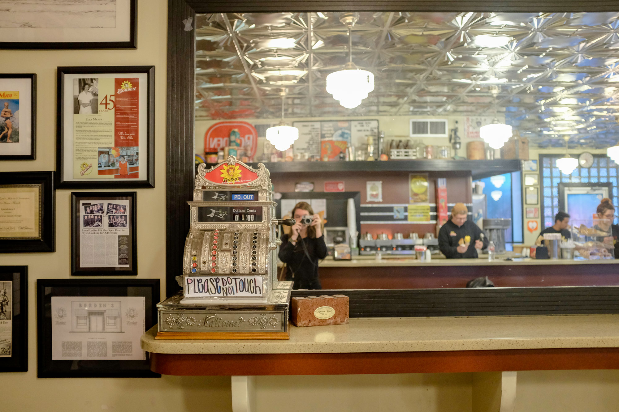 Krystal taking a photo inside Borden's Ice Cream, you can see her in the mirror