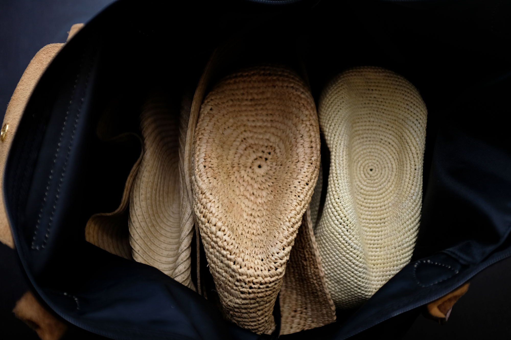 all three hats nestled in the tote bag