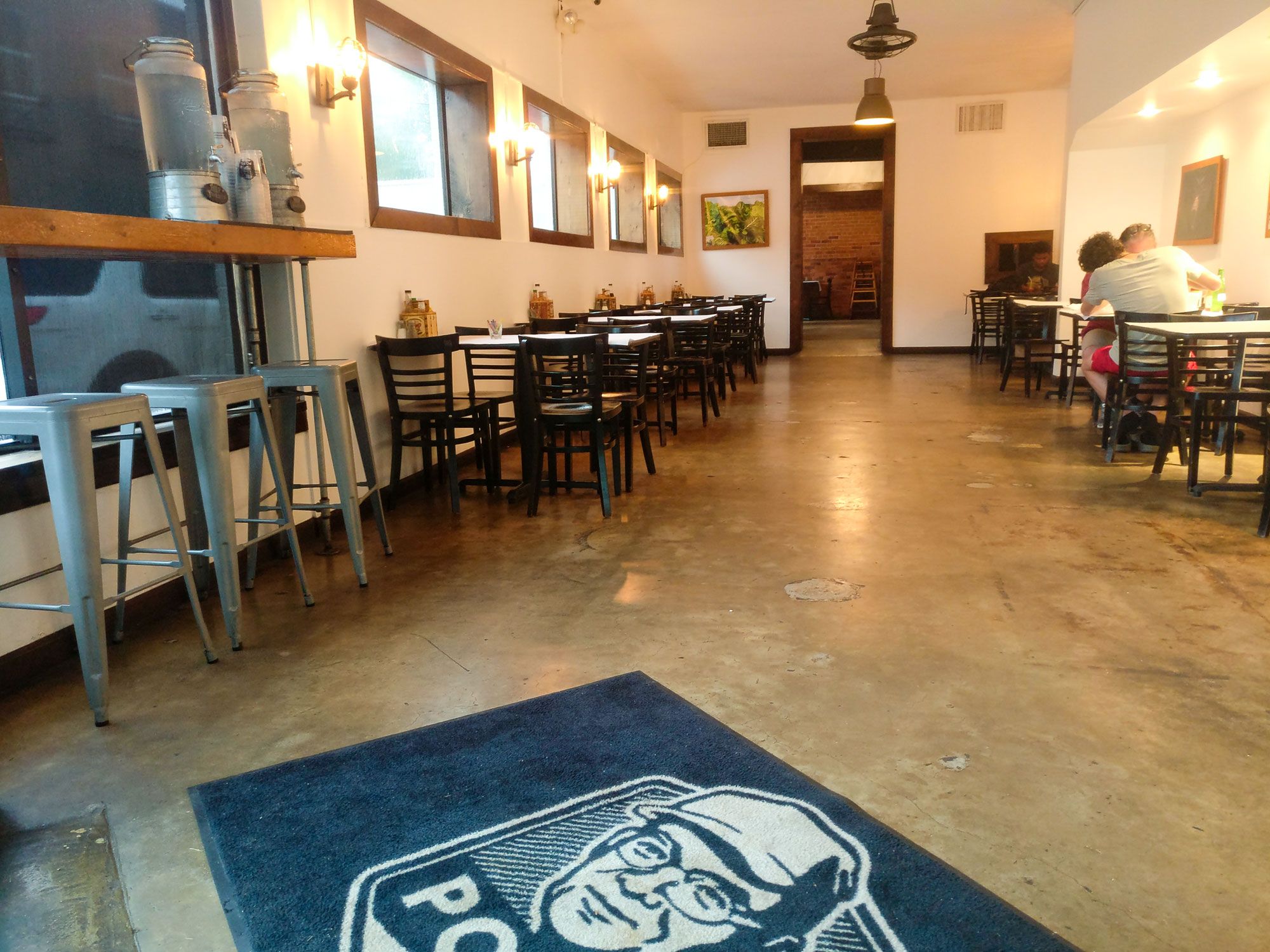 Interior of Pop's Poboys. It is pretty empty except for one couple eating on the side