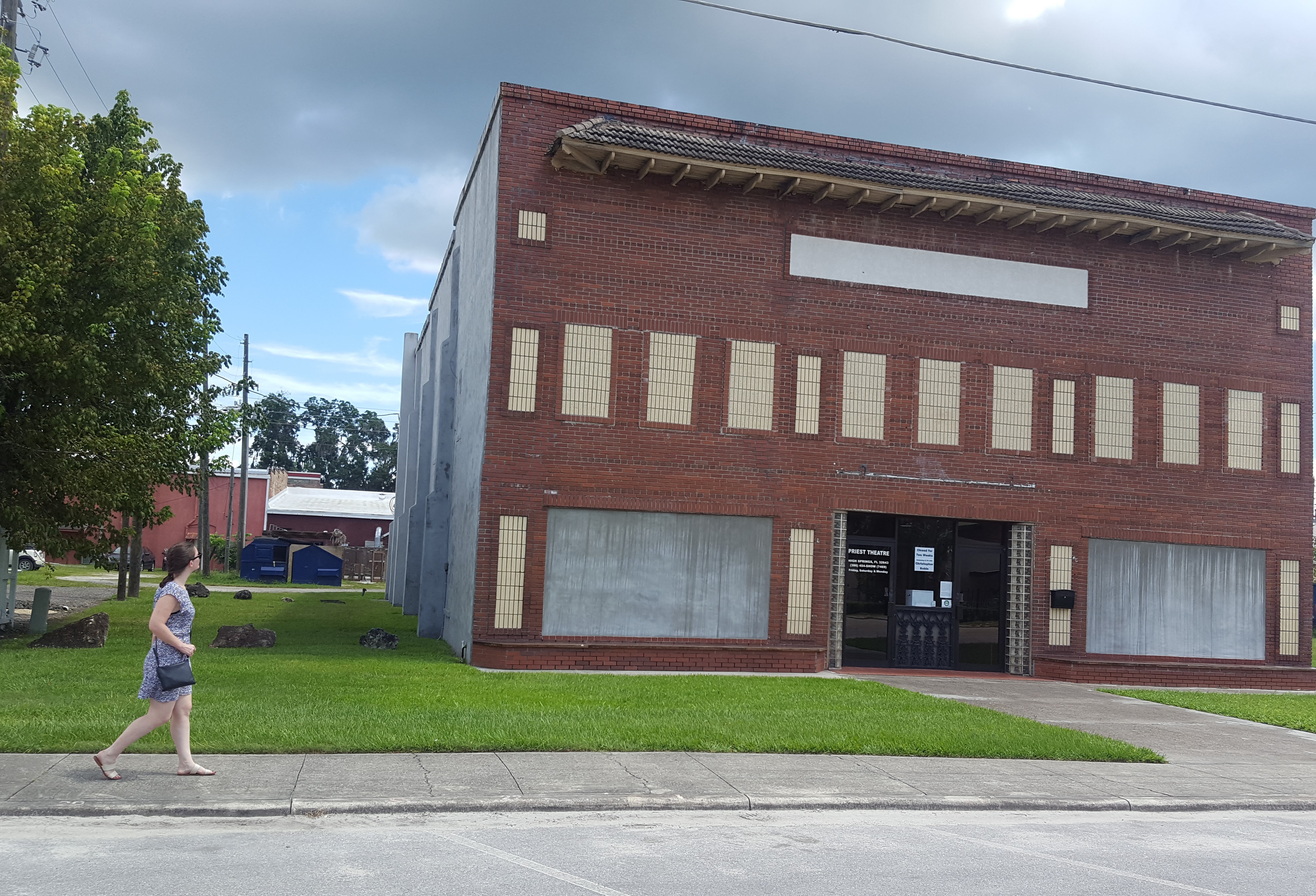 Alyssa walking in High Springs, Florida with an old building in the background
