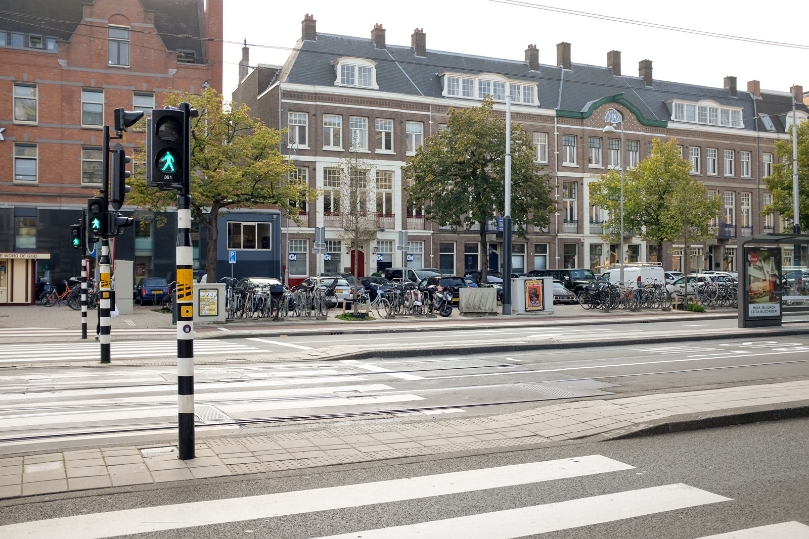 A crosswalk in Amsterdam with bikes in the distance