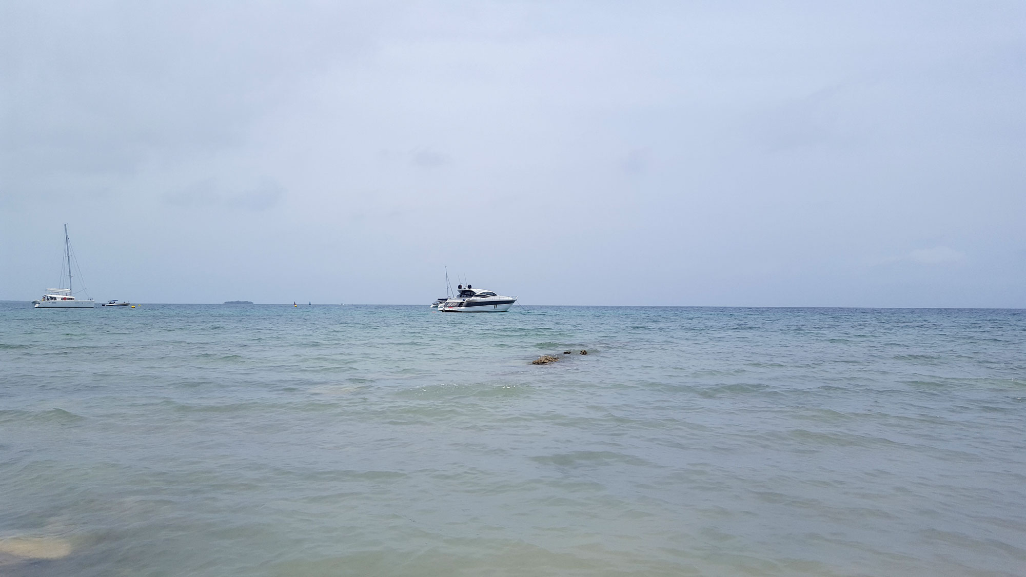 View of the open water; there is a boat in the middle distance