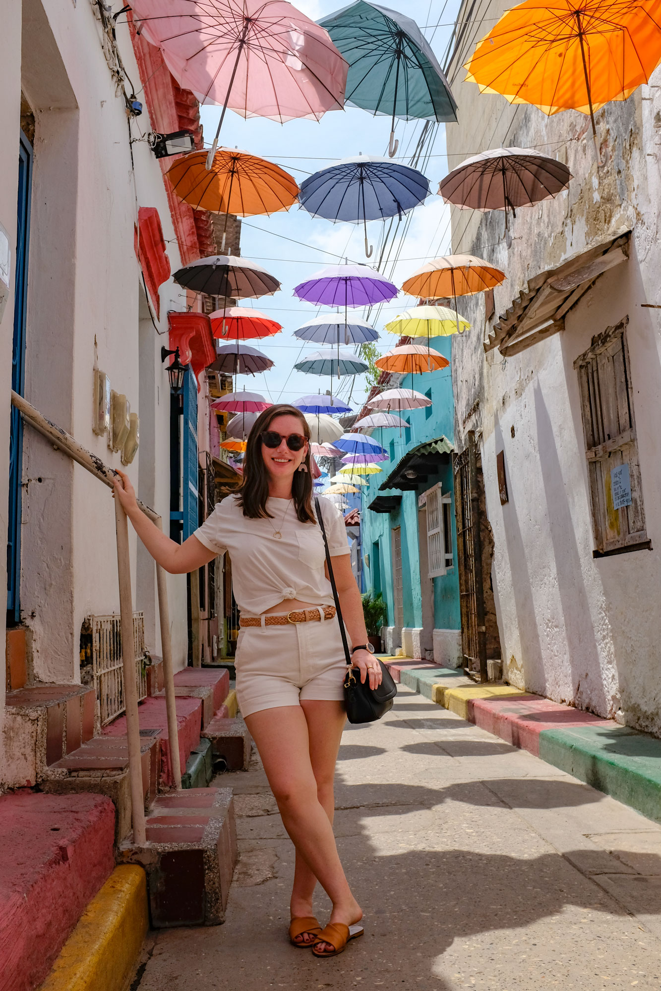 Alyssa stands under the colorful Cartagena Umbrellas