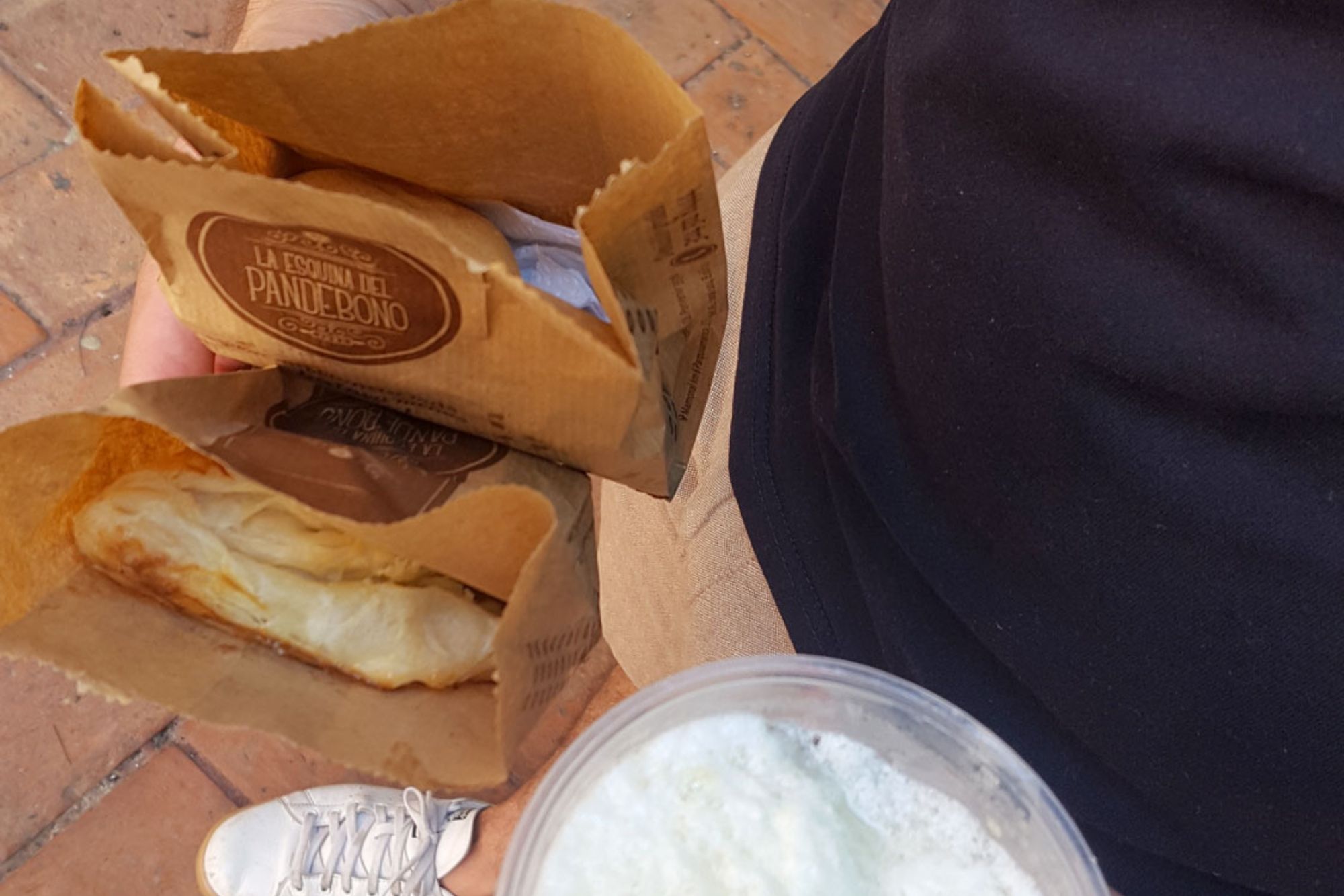 Michael holding bags of pastries from La Esquina del Pandebono