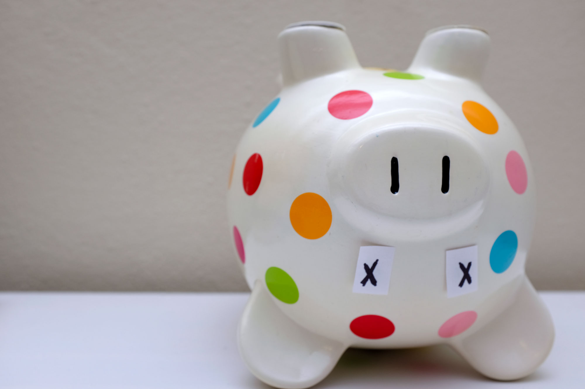 Upside-down piggy bank with "x" over its eyes