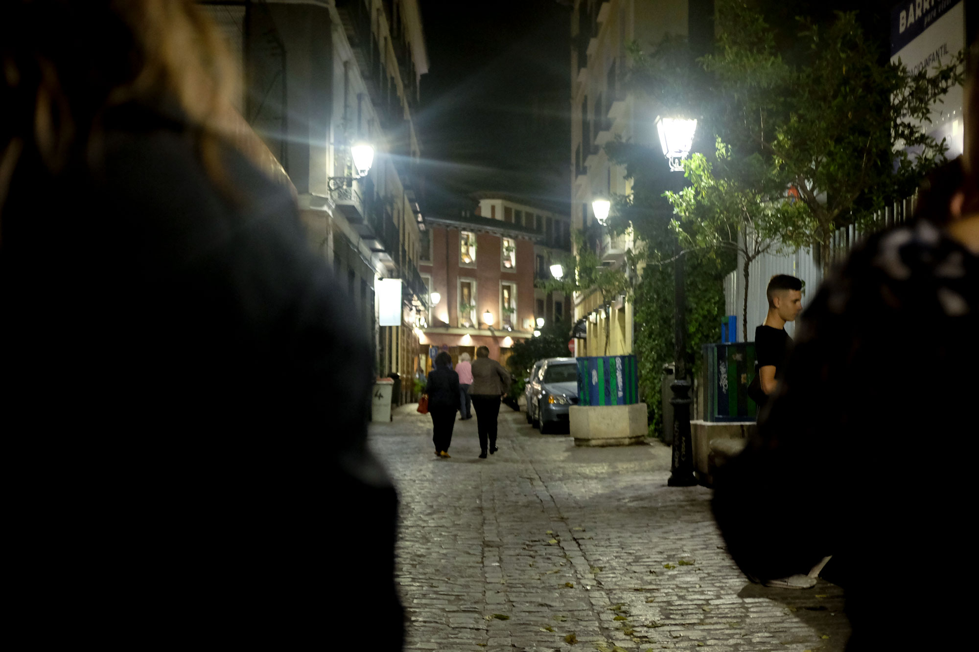 A group walks down the street for tapas