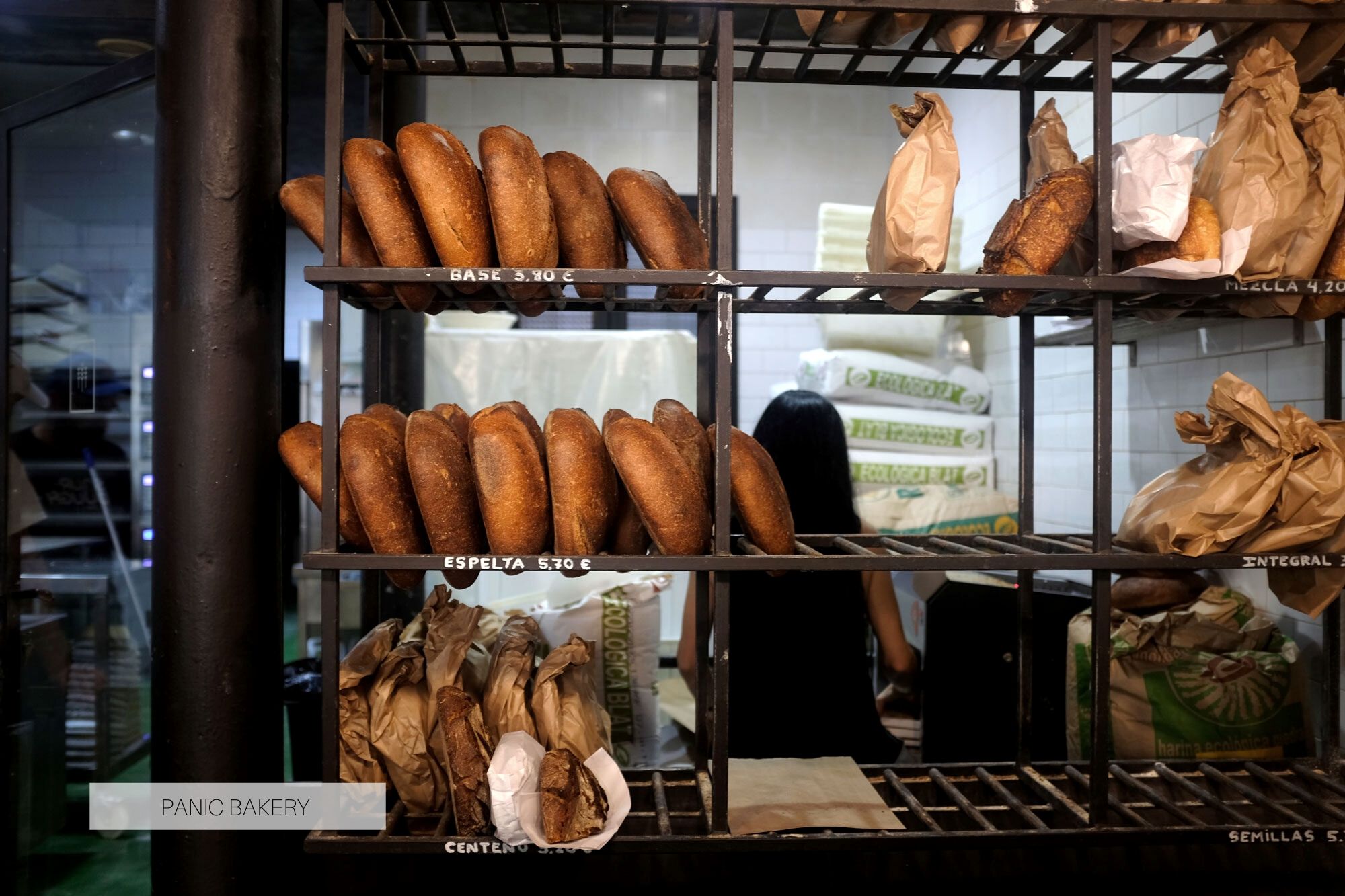 Loaves of bread on racks at Panic Bakery