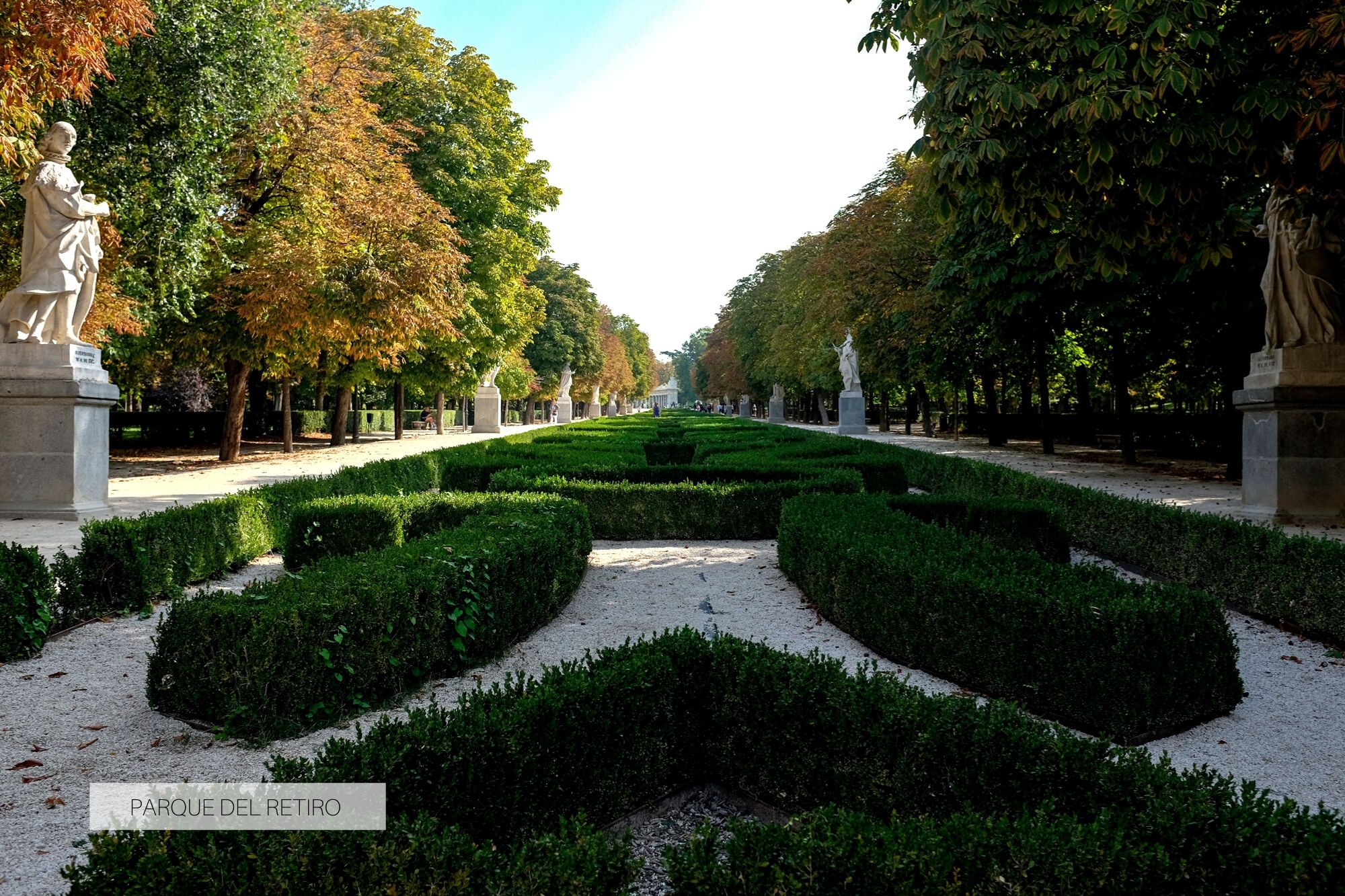 Gardens of the Parque del Retiro with sculptures along the path