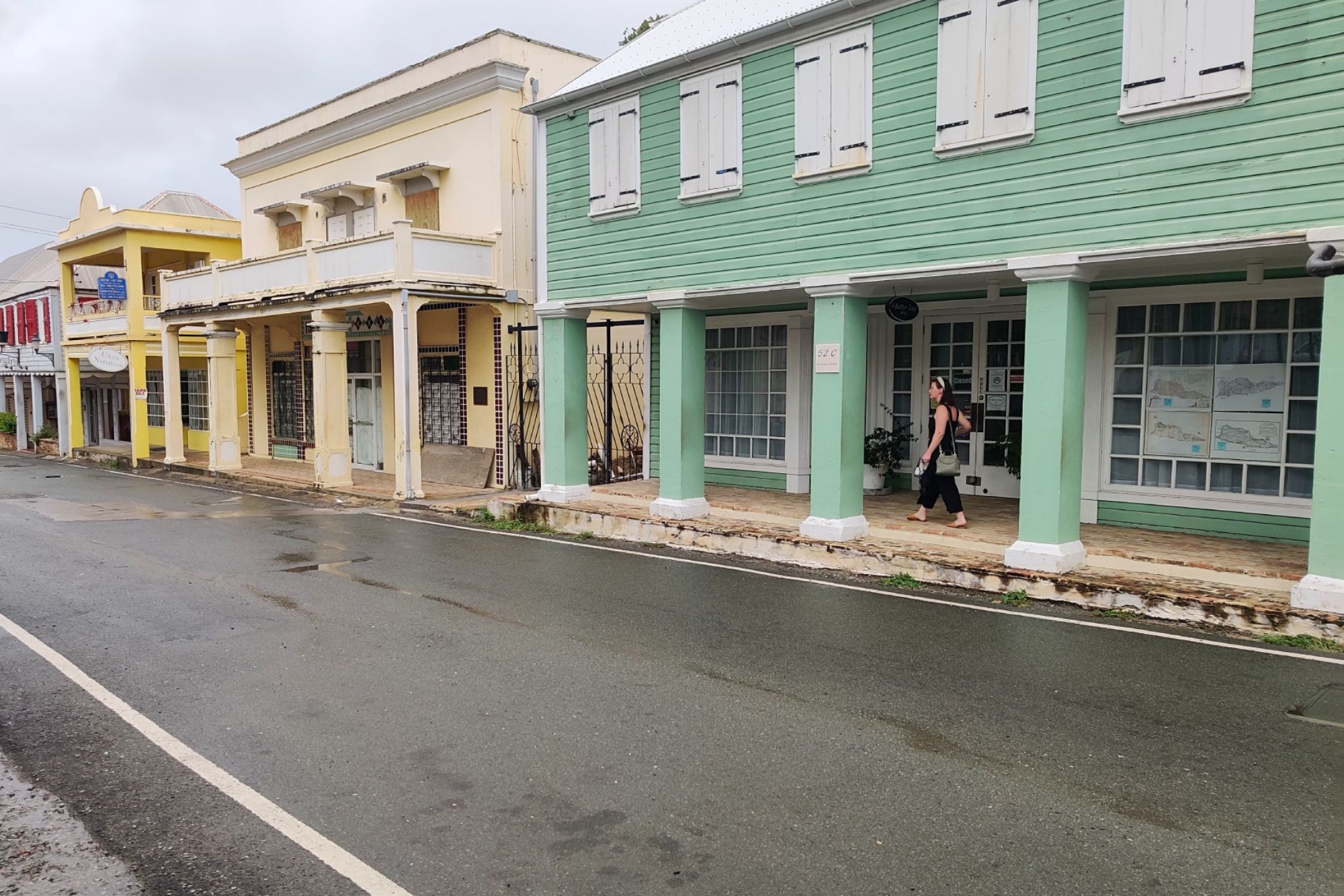 Alyssa stands among the pastel buildings in Christiansted