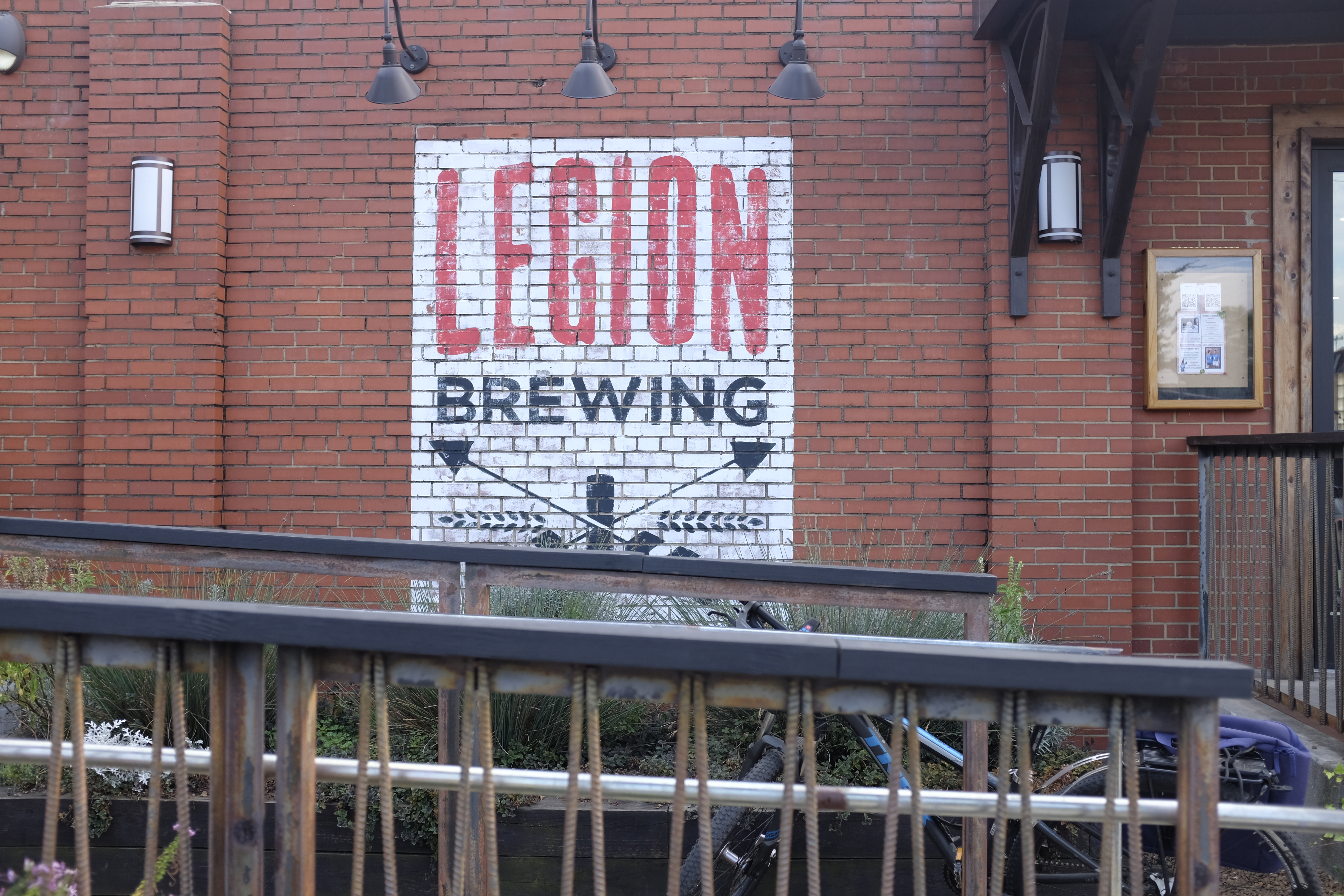 Exterior of brick building with the words Legion Brewing in all caps on a white brick background