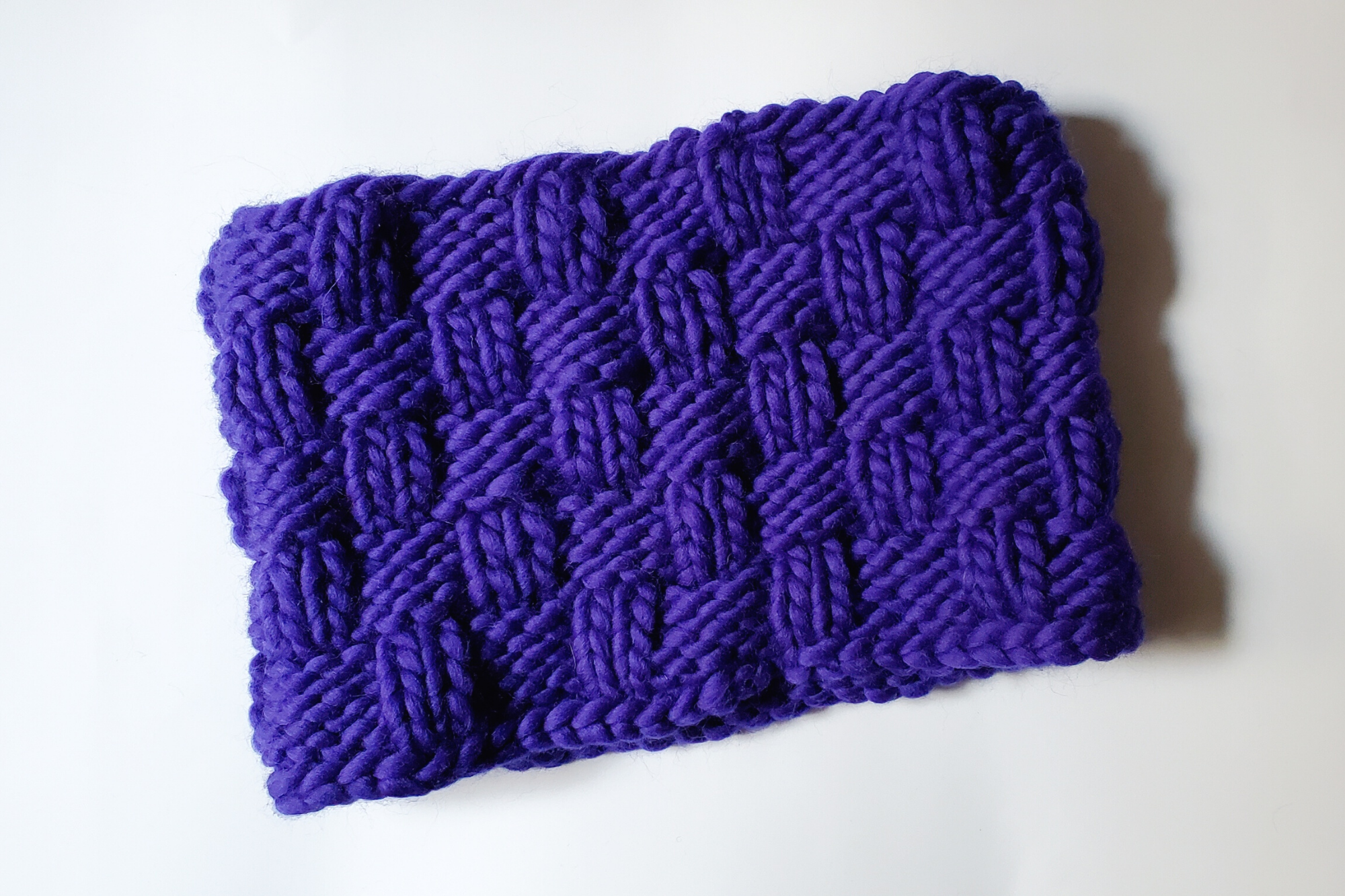 A purply-blue snood knit in a basketweave pattern