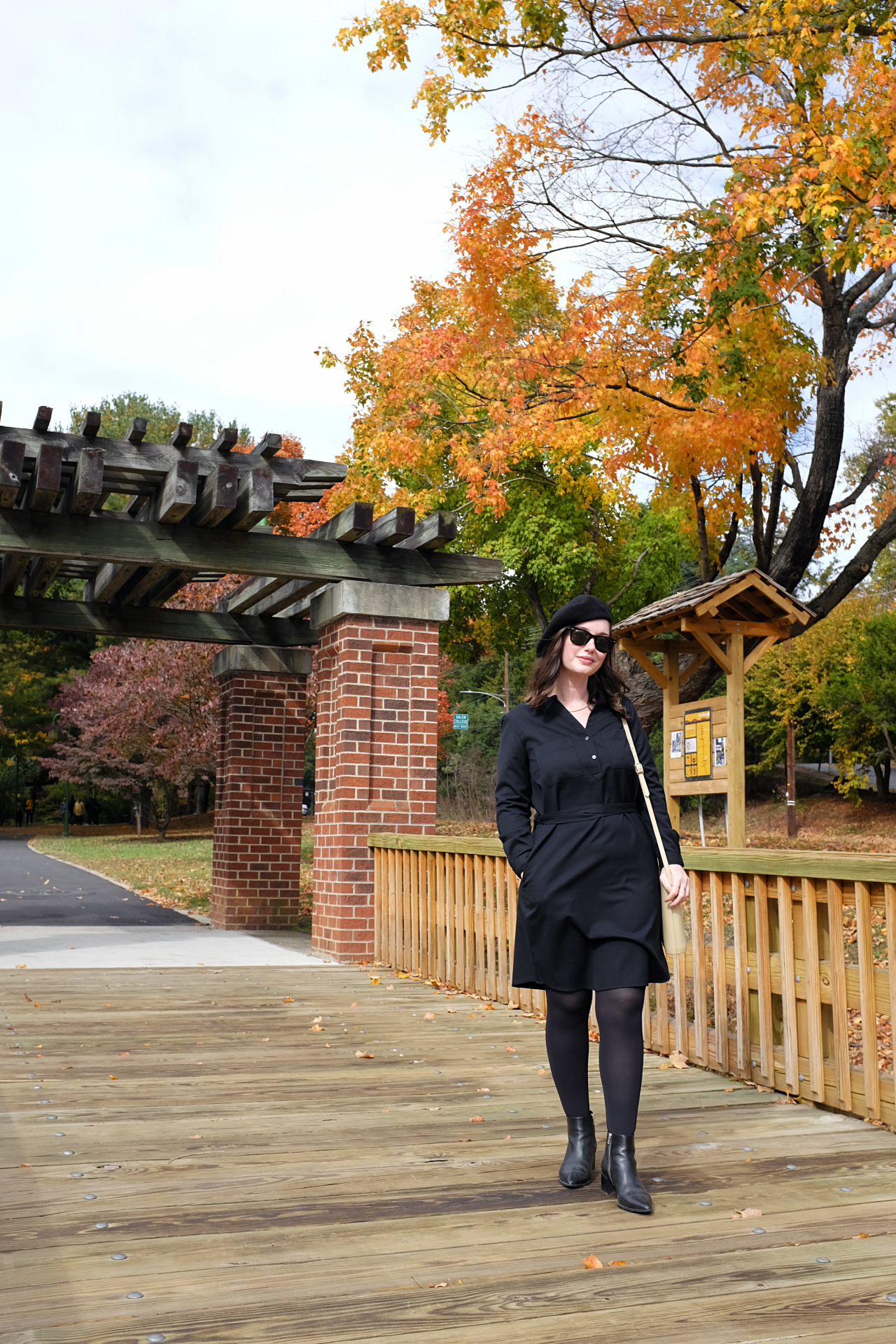 Alyssa wears an all-black outfit on a bridge in Old Salem