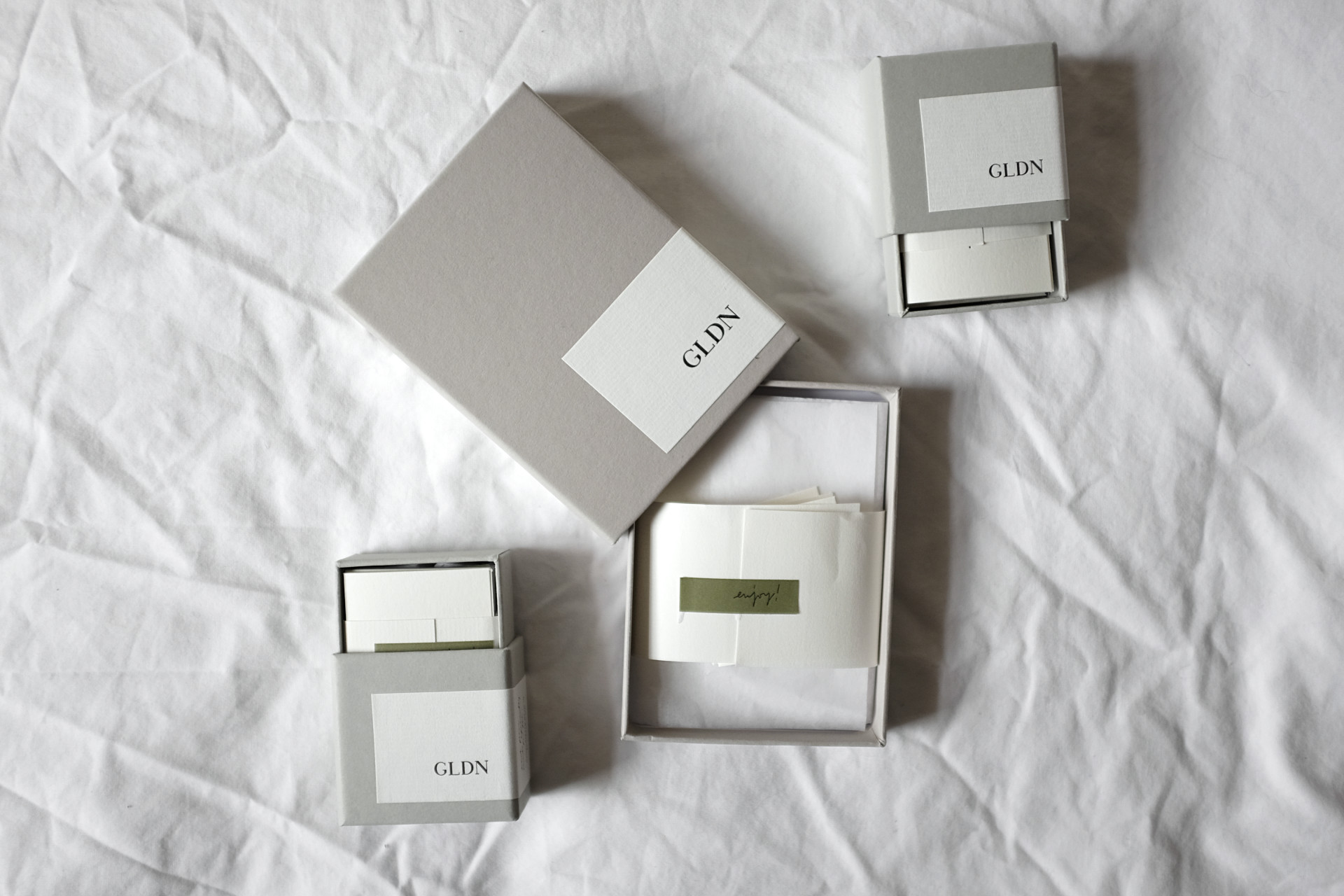a set of GLDN jewelry boxes atop a white sheet