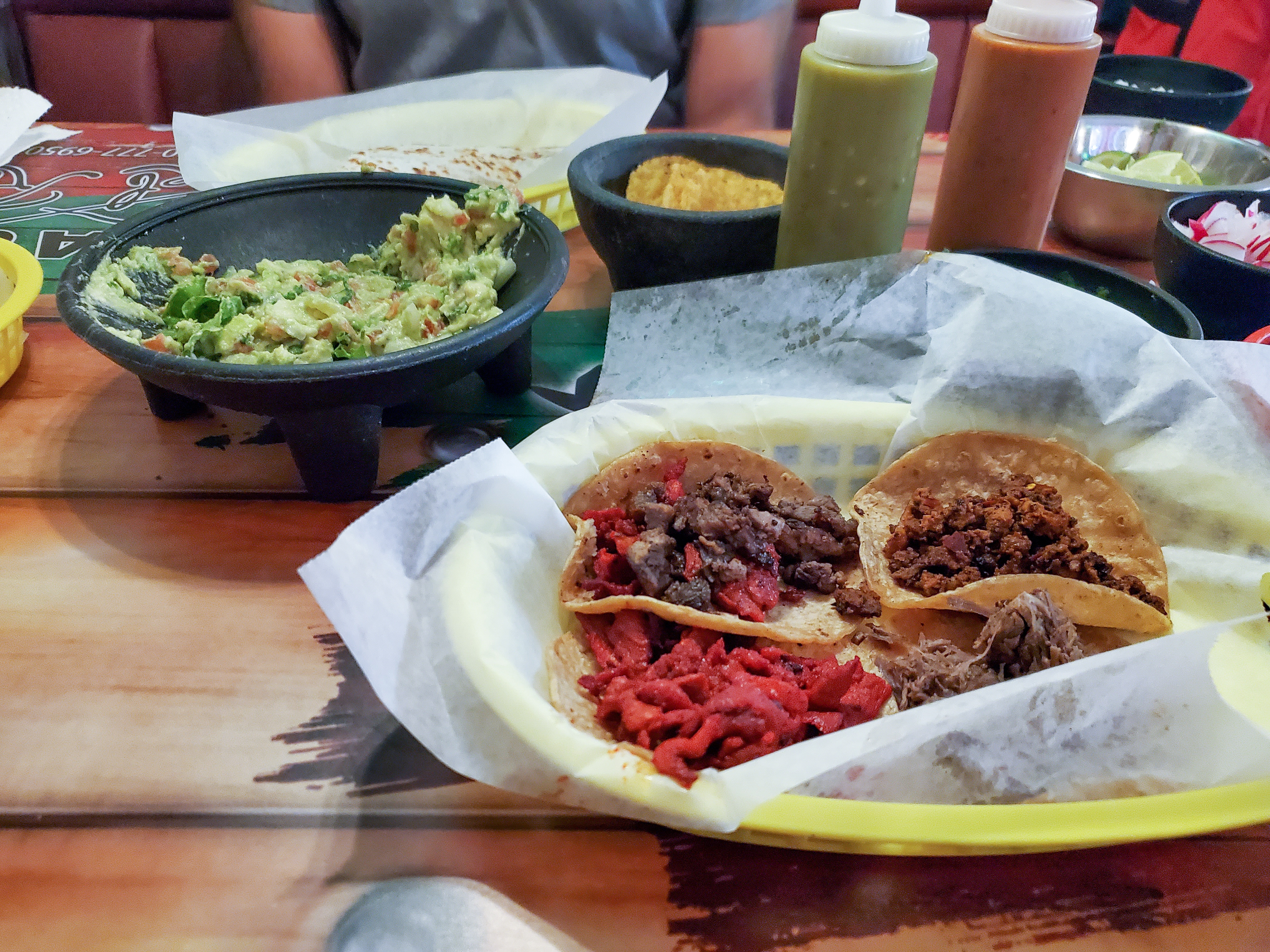 A plate of tacos and guac at Tacos El Regio