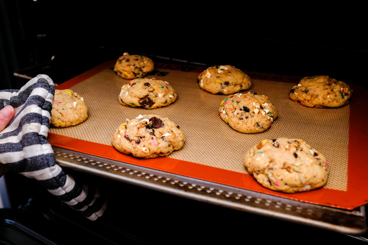 Tray of cookies coming out of the oven