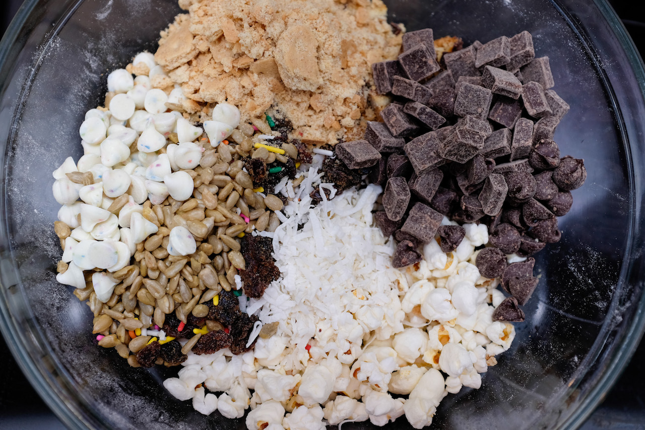 Mixture of assorted cookies ingredients: nuts, chocolate chips, coconut, etc.