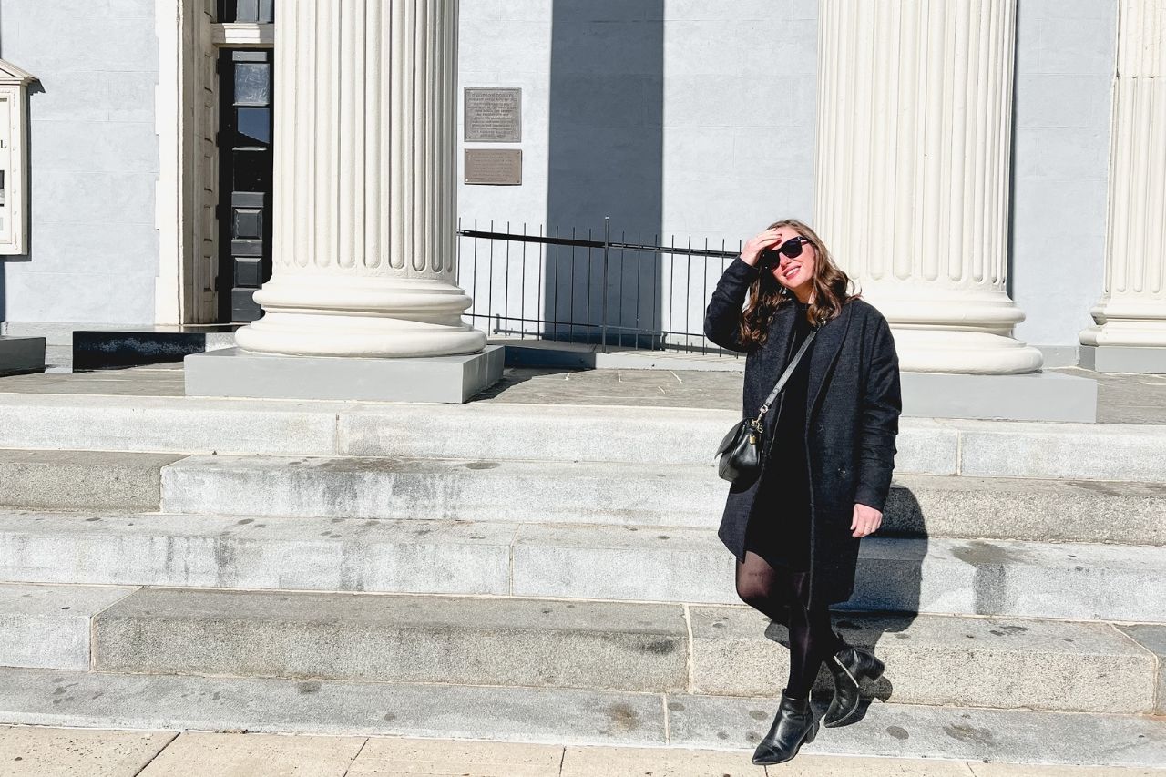Alyssa stands in front of the Lexington Courthouse, shielding her eyes from the sun