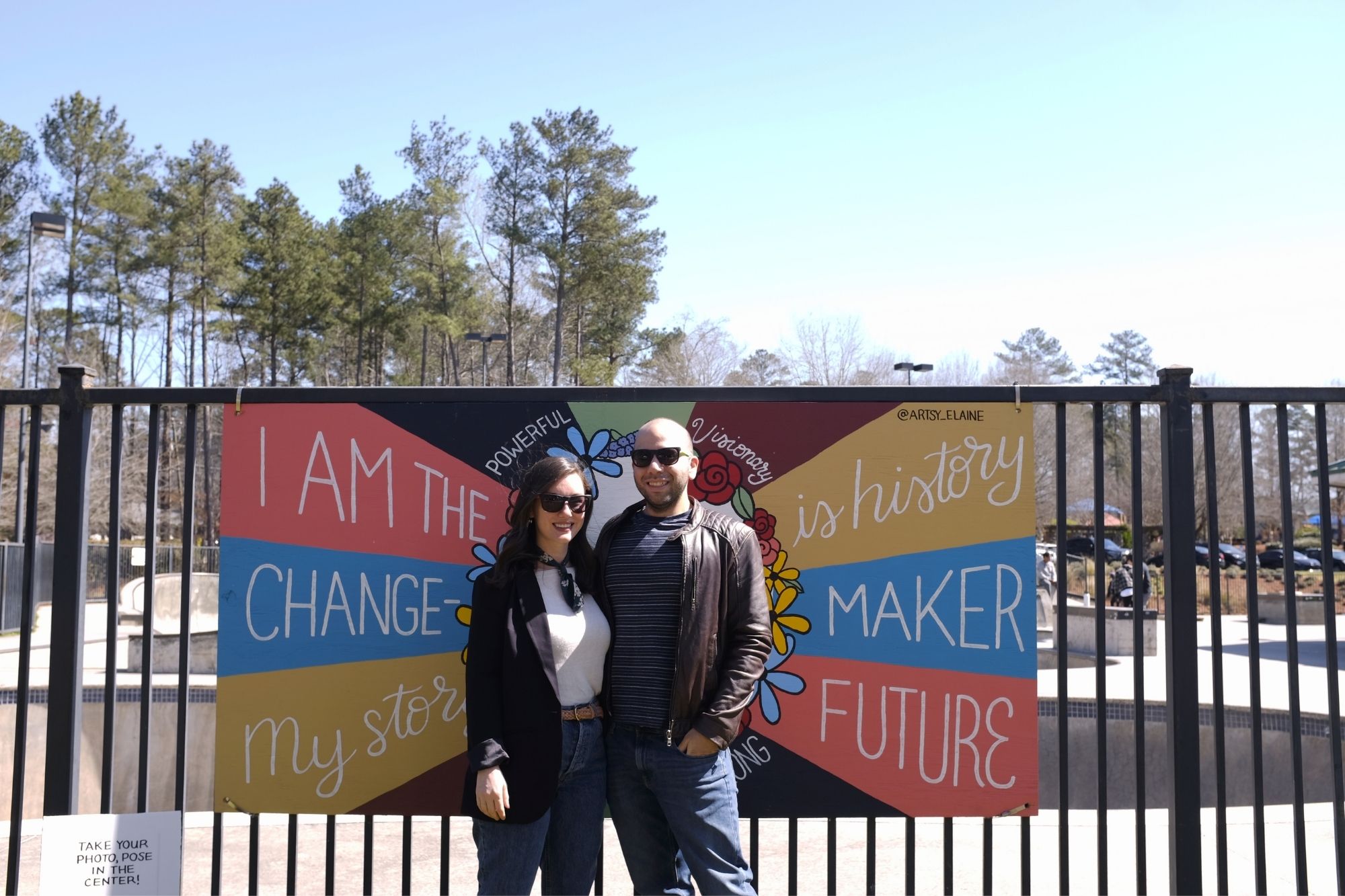 Alyssa and Michael stand in the photo spot for one of the murals at Brook Run Park