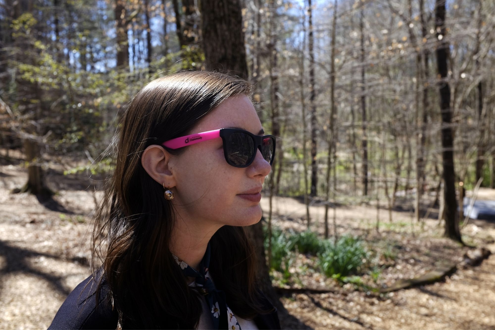 Alyssa wears a pair of sunglasses with Discover Dunwoody printed on the side