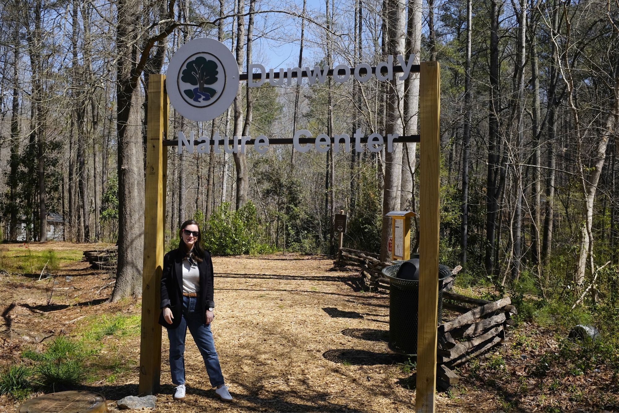 Alyssa stands under the Dunwoody Nature Center sign