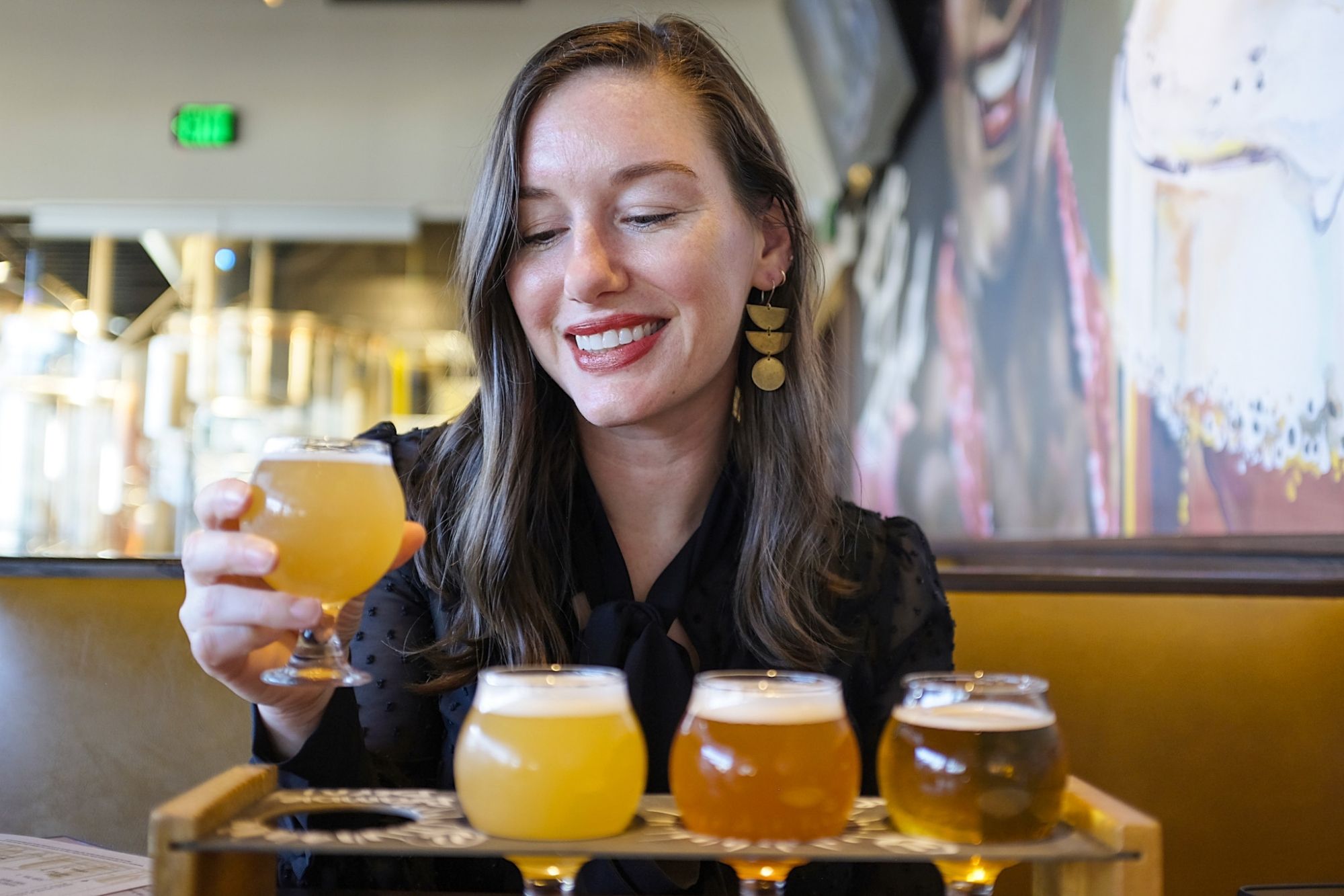 Alyssa chooses one beer from a beer flight