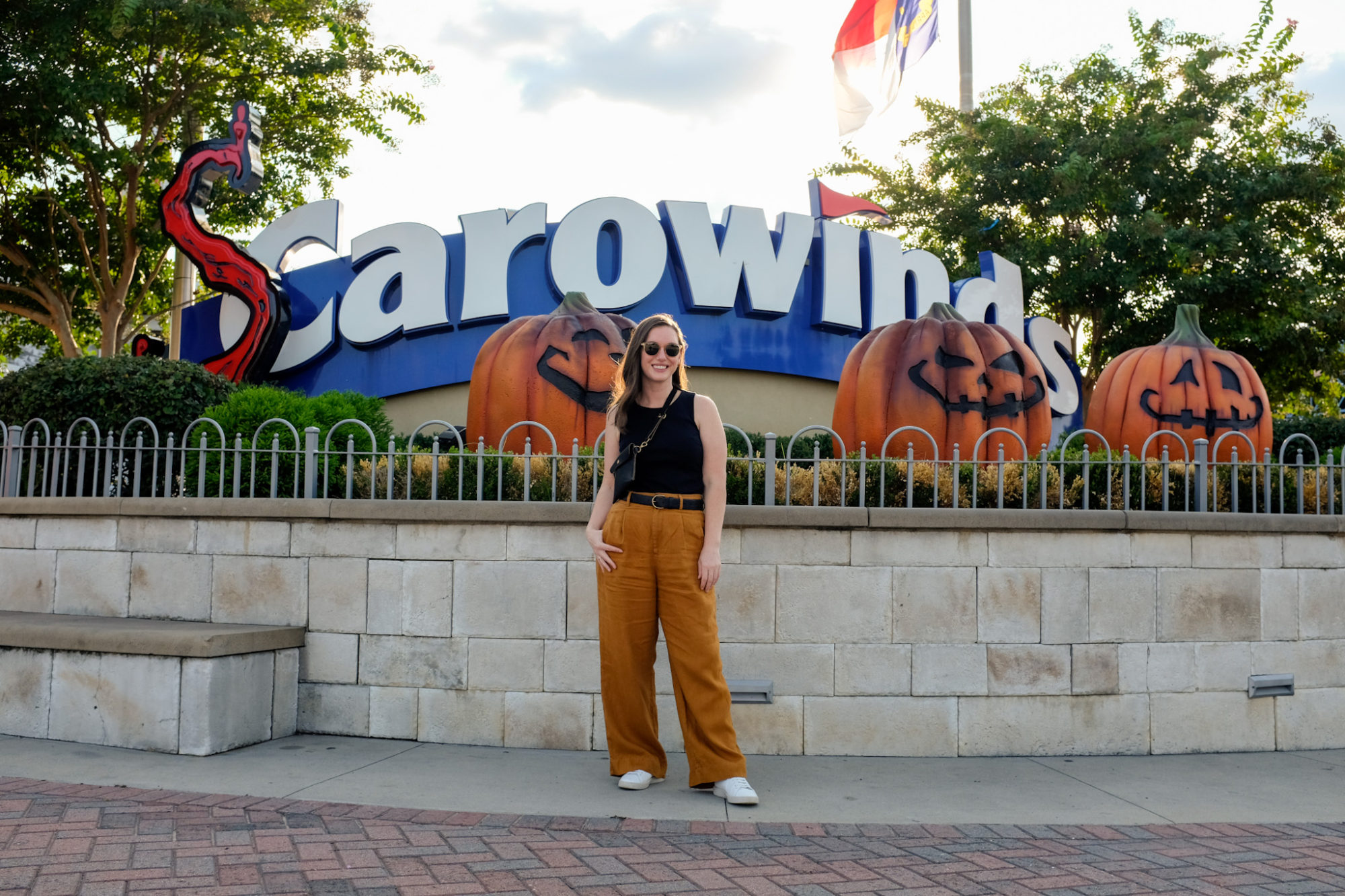 Alyssa stands in front of the SCarowinds sign