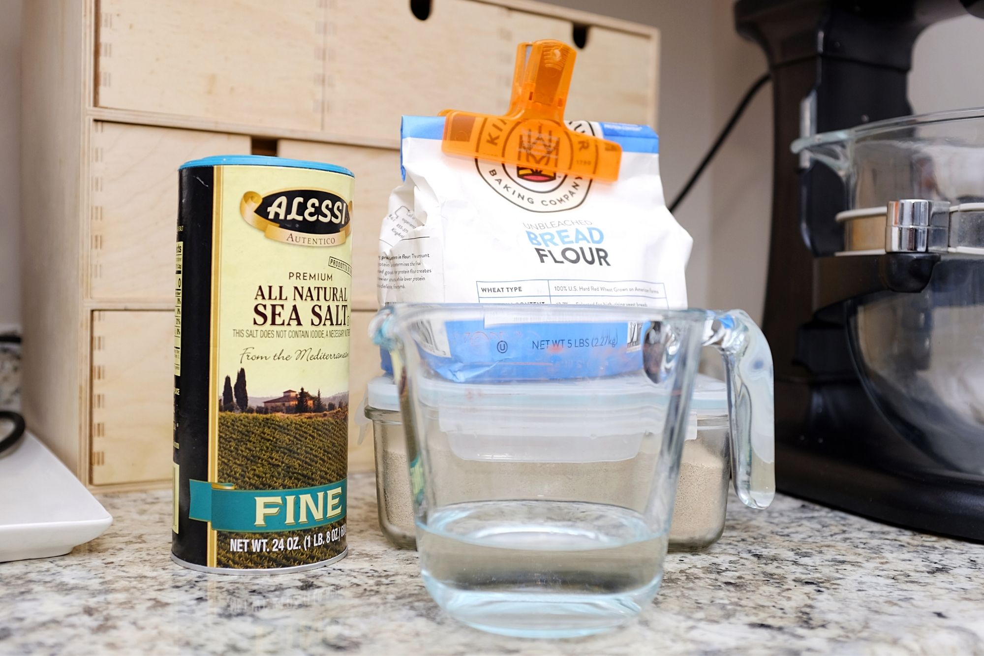 salt, flour, yeast and water on a counter