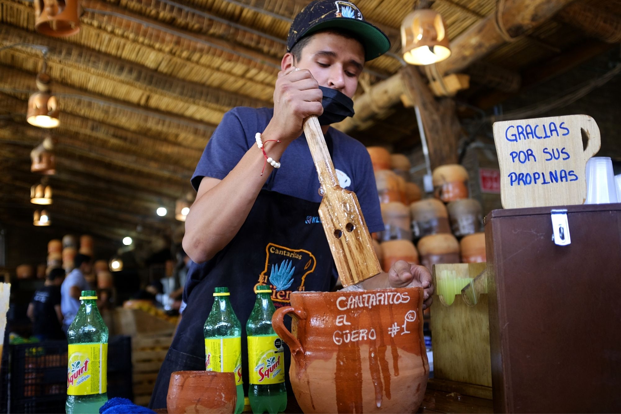 A bartender mixing a cantarito at Cantaritos el Guero